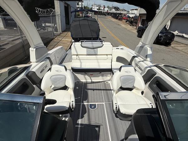 2023 Chaparral 267 SSX boat interior with white seating and sleek design.