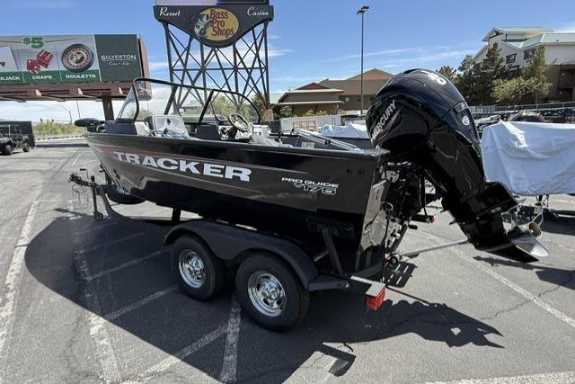 2025 Tracker Pro Guide V-175 WT boat on trailer in parking lot.