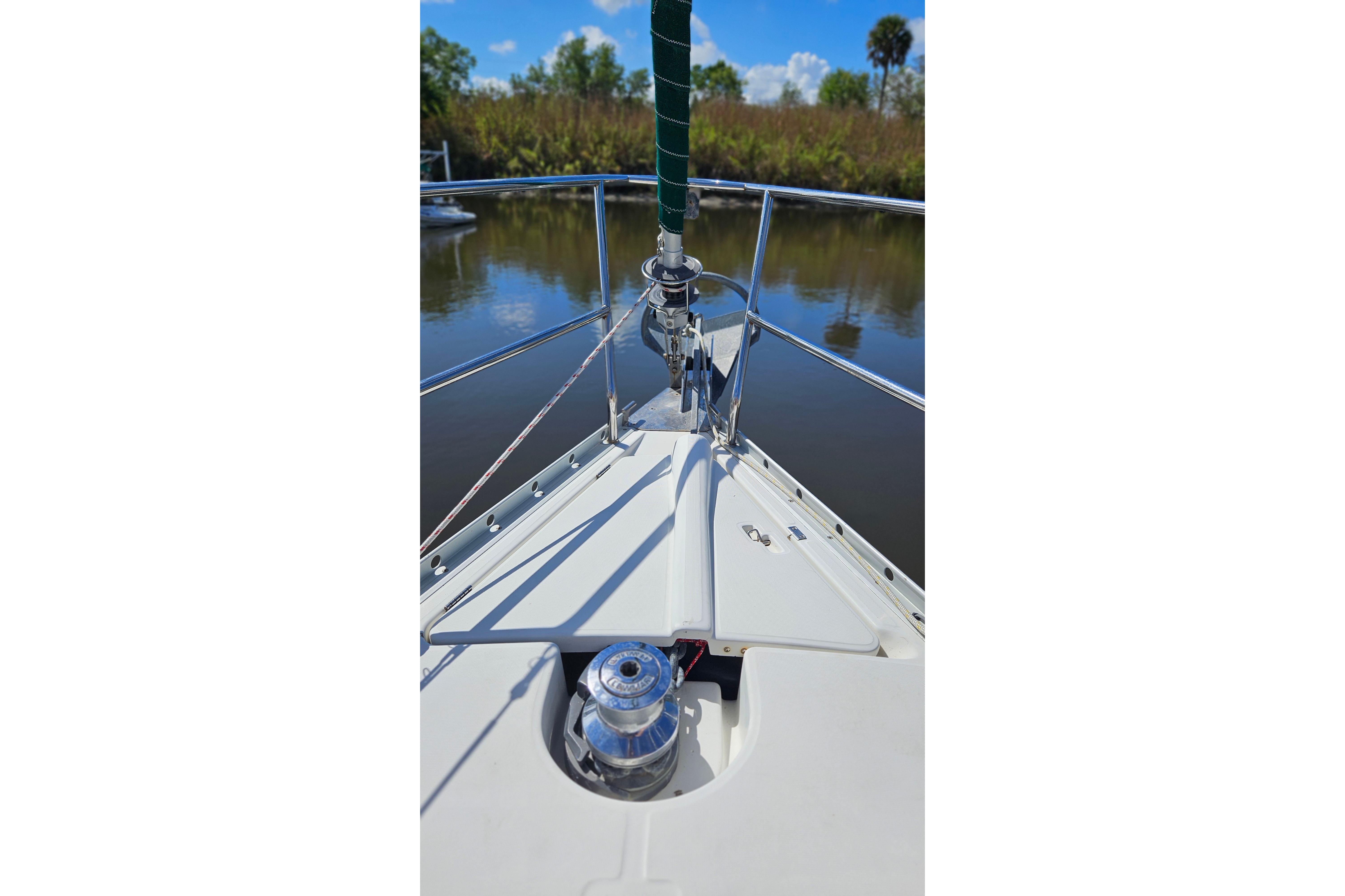 Bow view of 2000 Beneteau Oceanis Clipper 361 sailboat on calm water.