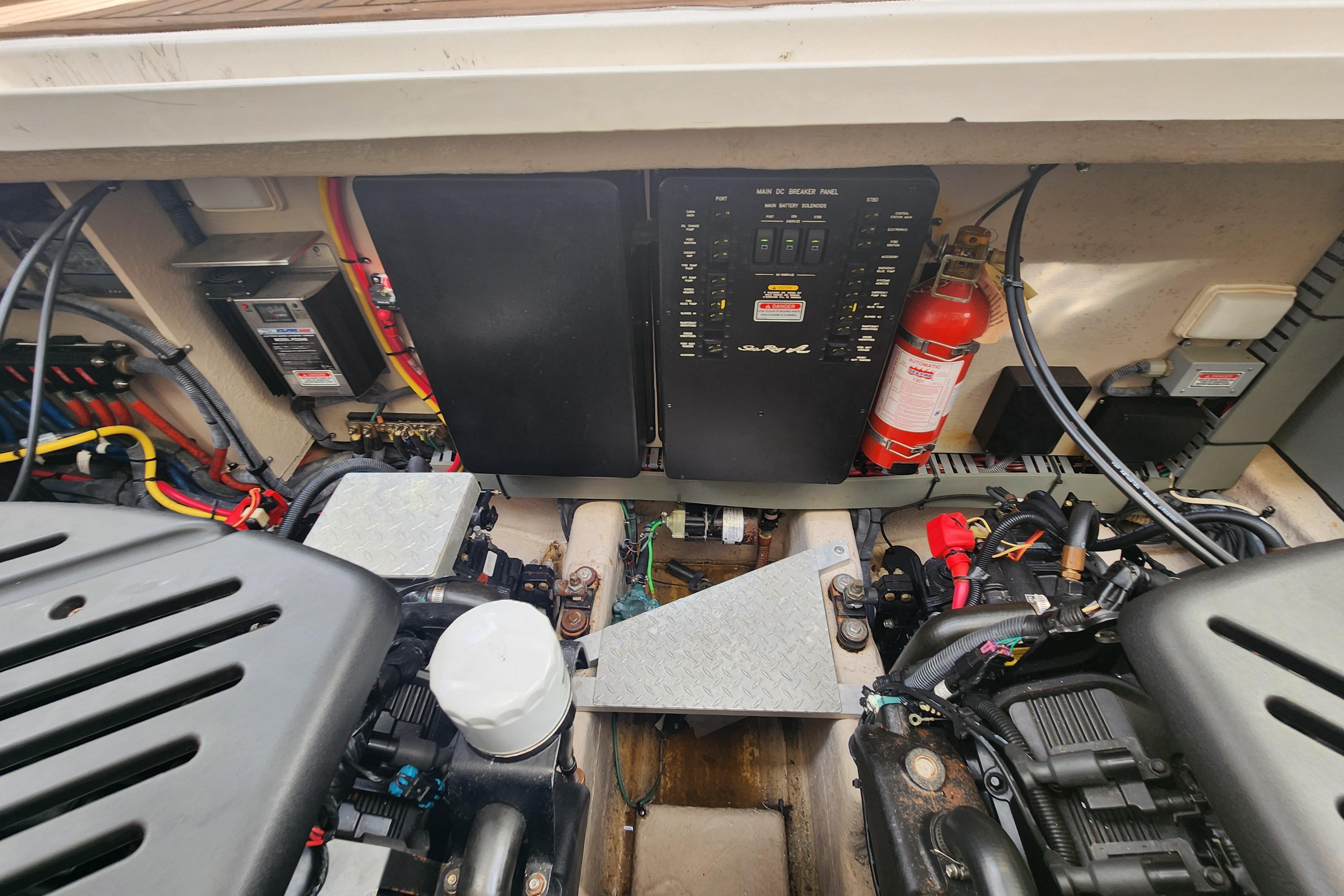 Engine compartment of a 2003 Sea Ray 360 Sundancer with electrical panel and fire extinguisher.
