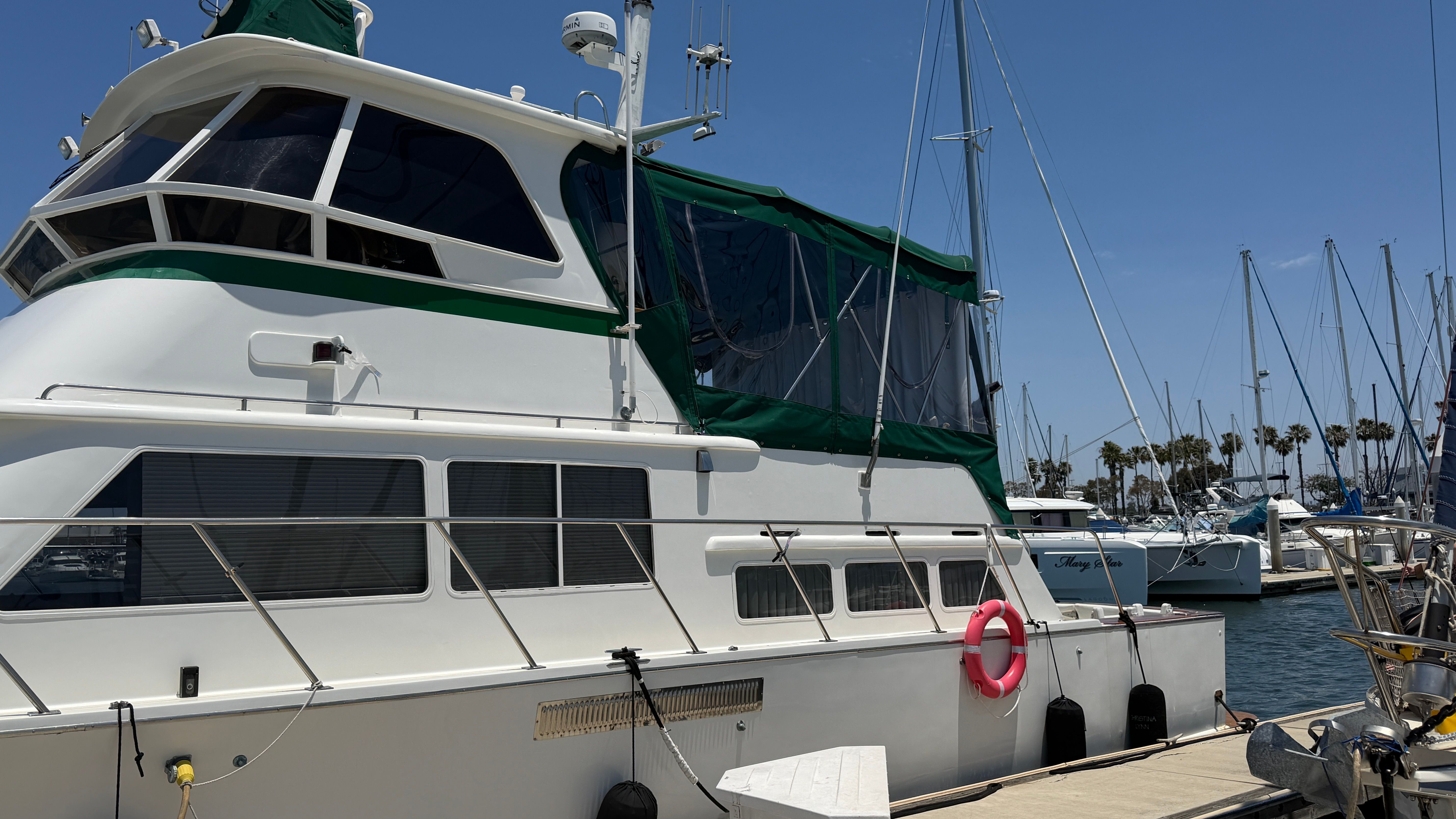 1966 Drake Yachtfisher docked, white with green accents.