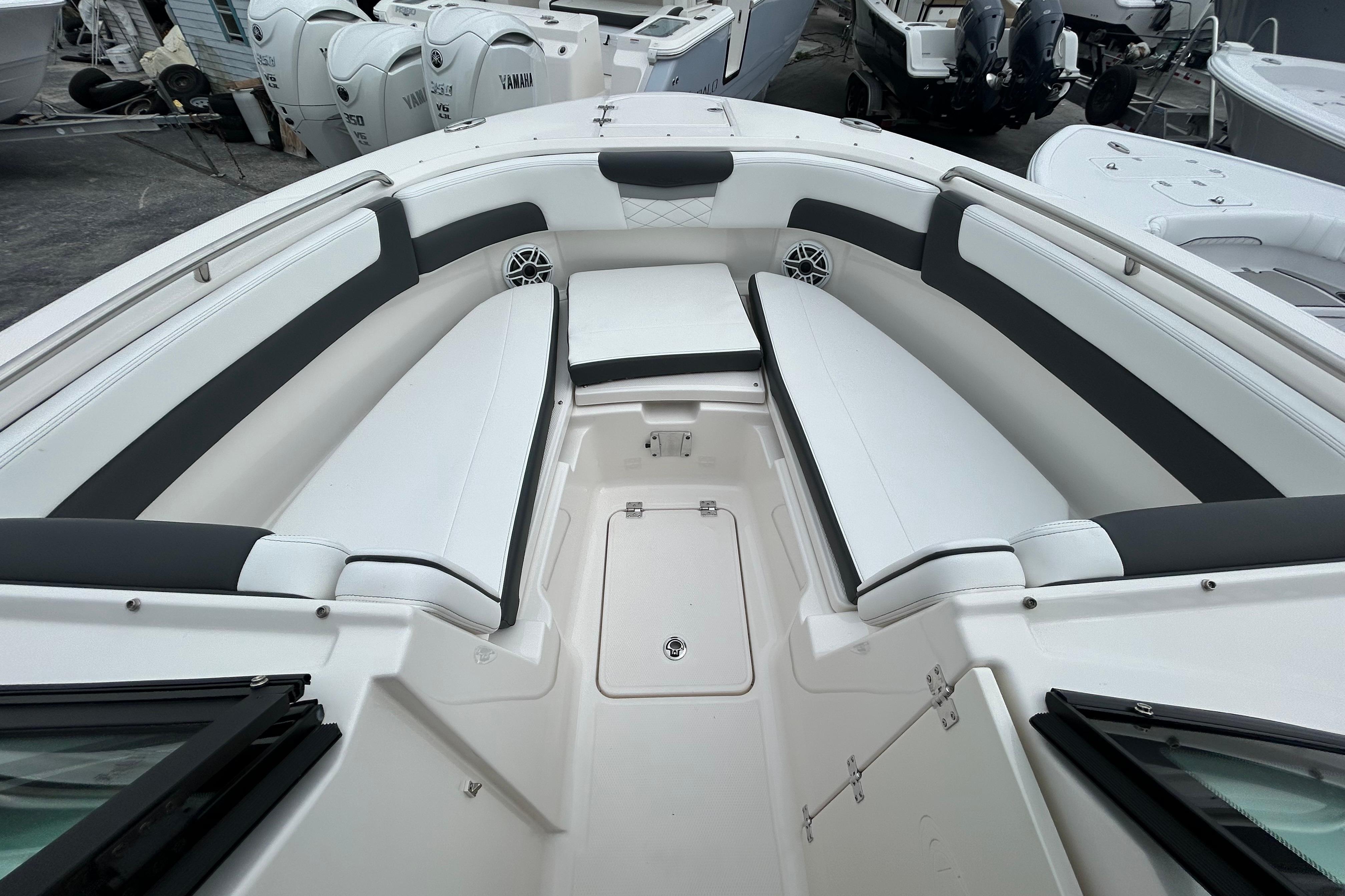 2026 Robalo R257 Dual Console boat interior with white seating and storage compartments.