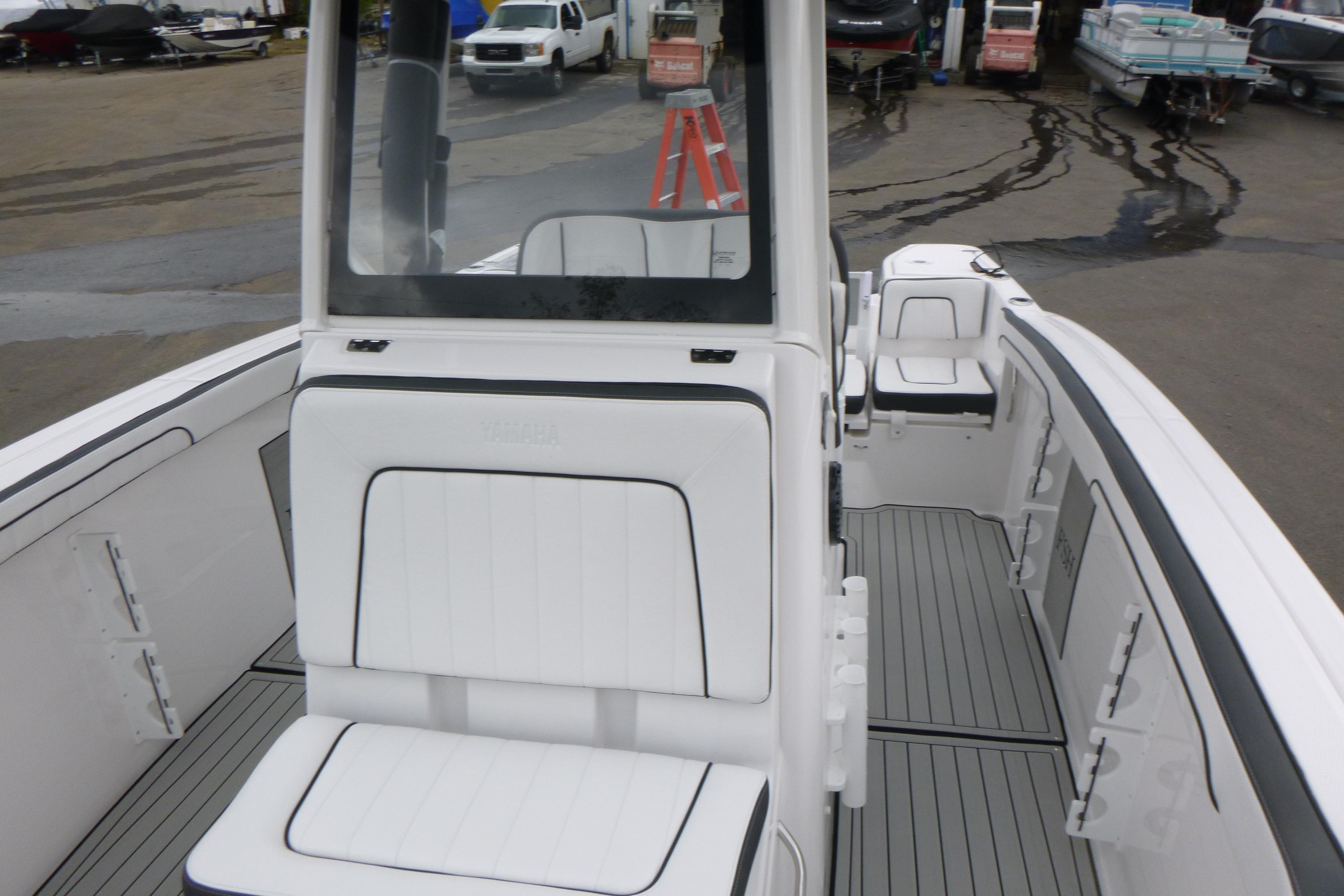 2026 Yamaha Boats 255 FSH Sport H interior with white seating and sleek design.
