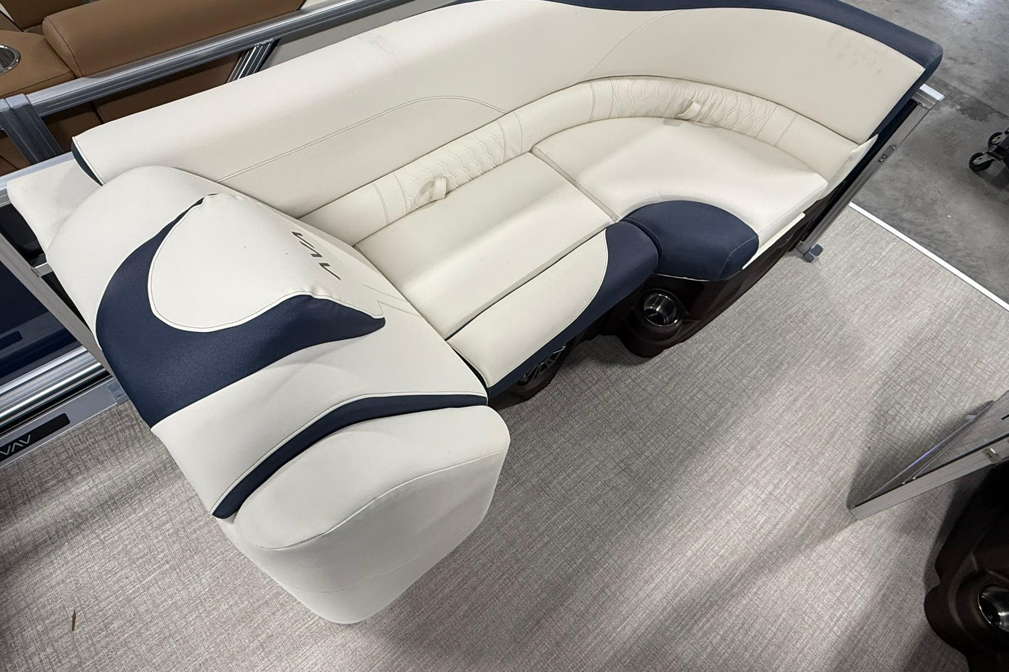 Luxurious seating on 2026 Avalon LSZ Elite 21' pontoon boat, featuring elegant cream and navy upholstery.