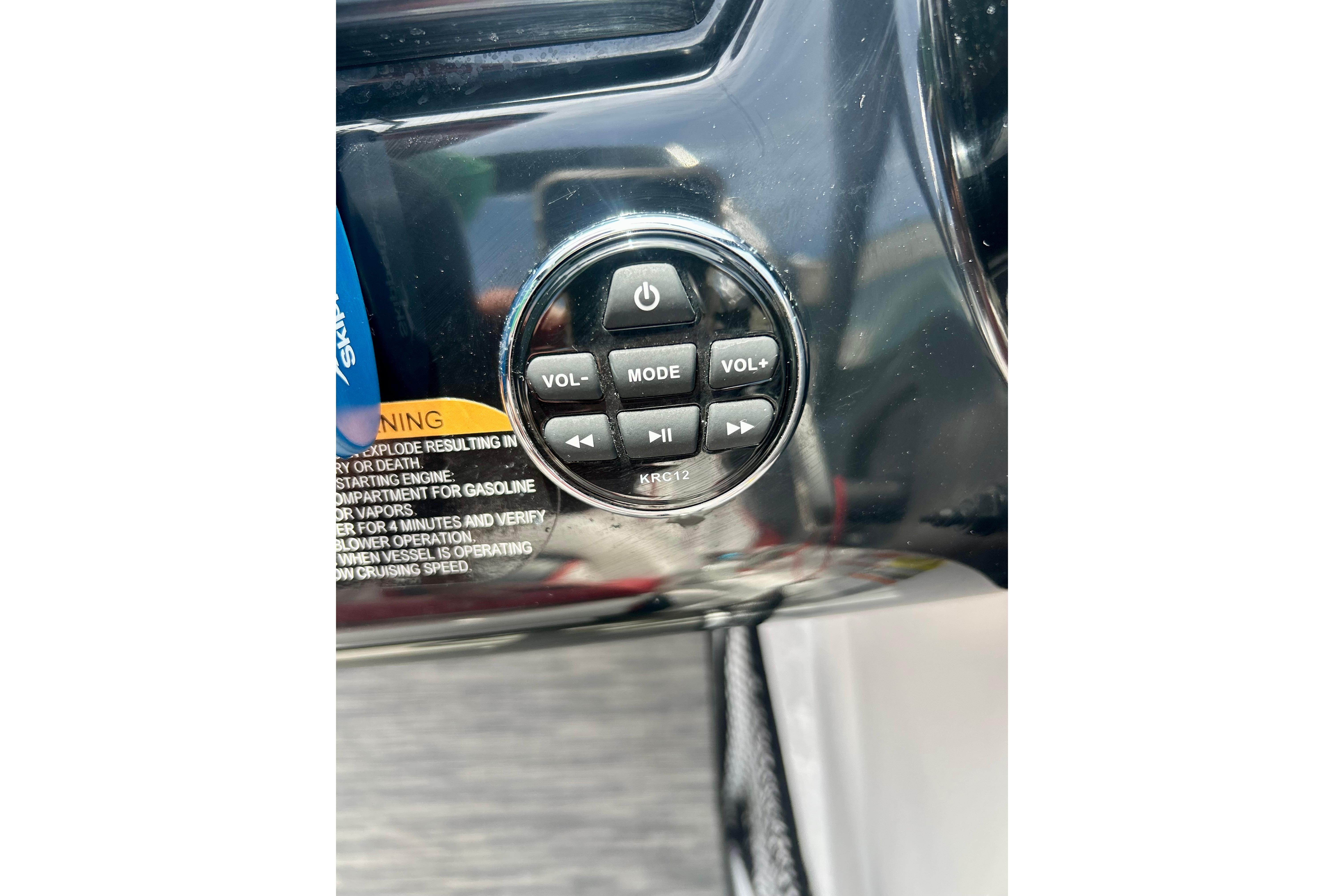 Control panel of a 2021 Scarab 195 ID boat with volume and mode buttons.
