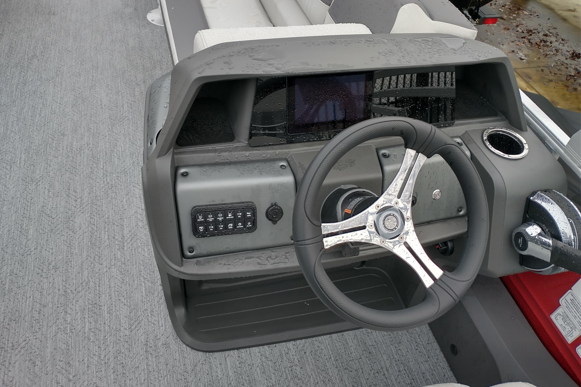 Steering console of 2026 Sun Tracker Fishin' Barge 22 DLX with modern controls.