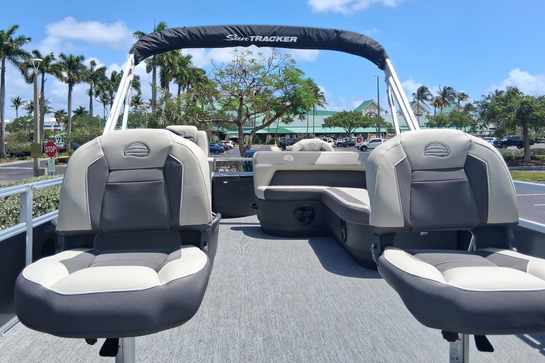 2026 Sun Tracker Bass Buggy 18 DLX pontoon boat with comfortable seating in a sunny setting.