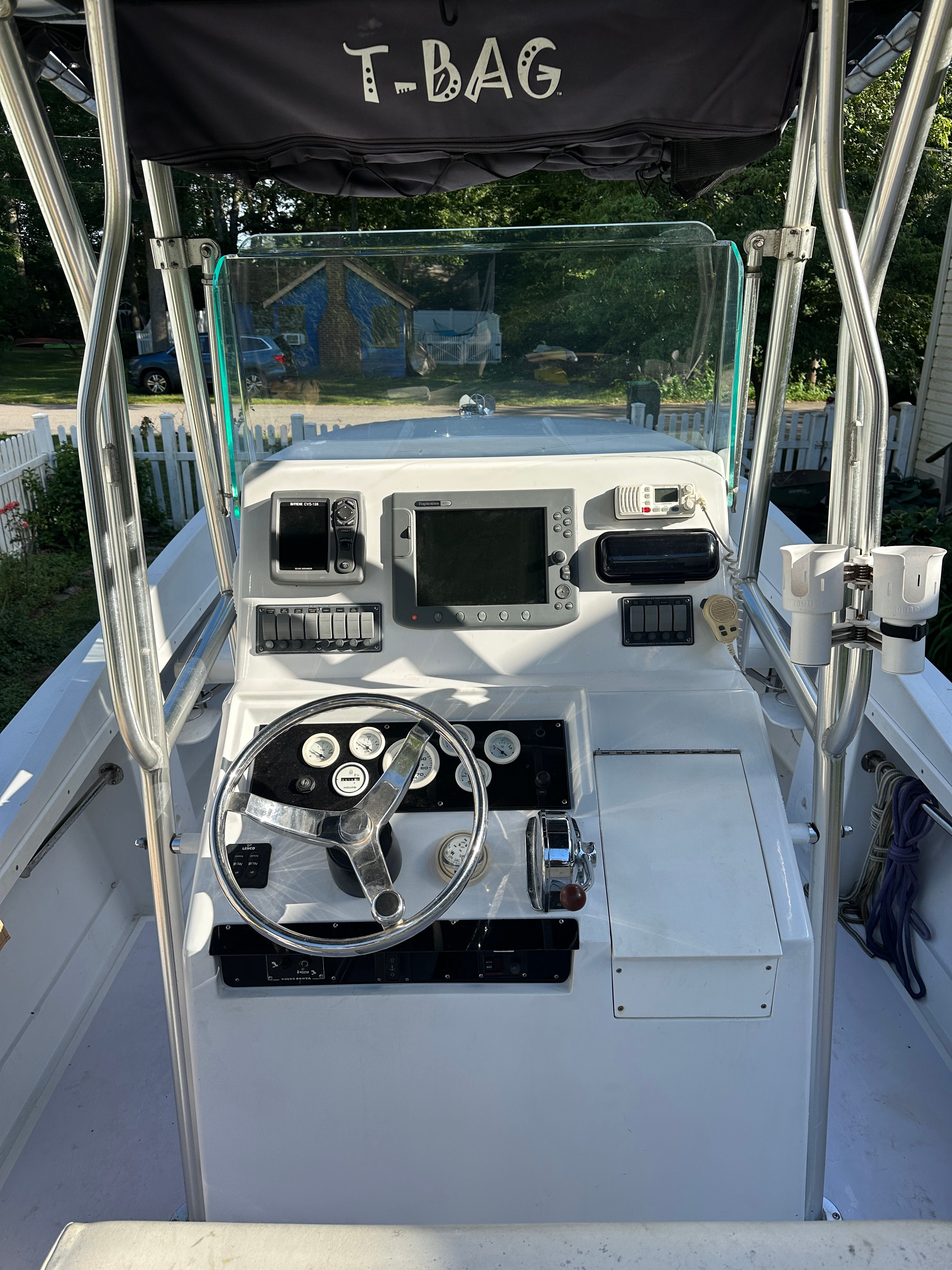 The cockpit of a 1976 Blackfin Fisherman boat with steering and electronics.