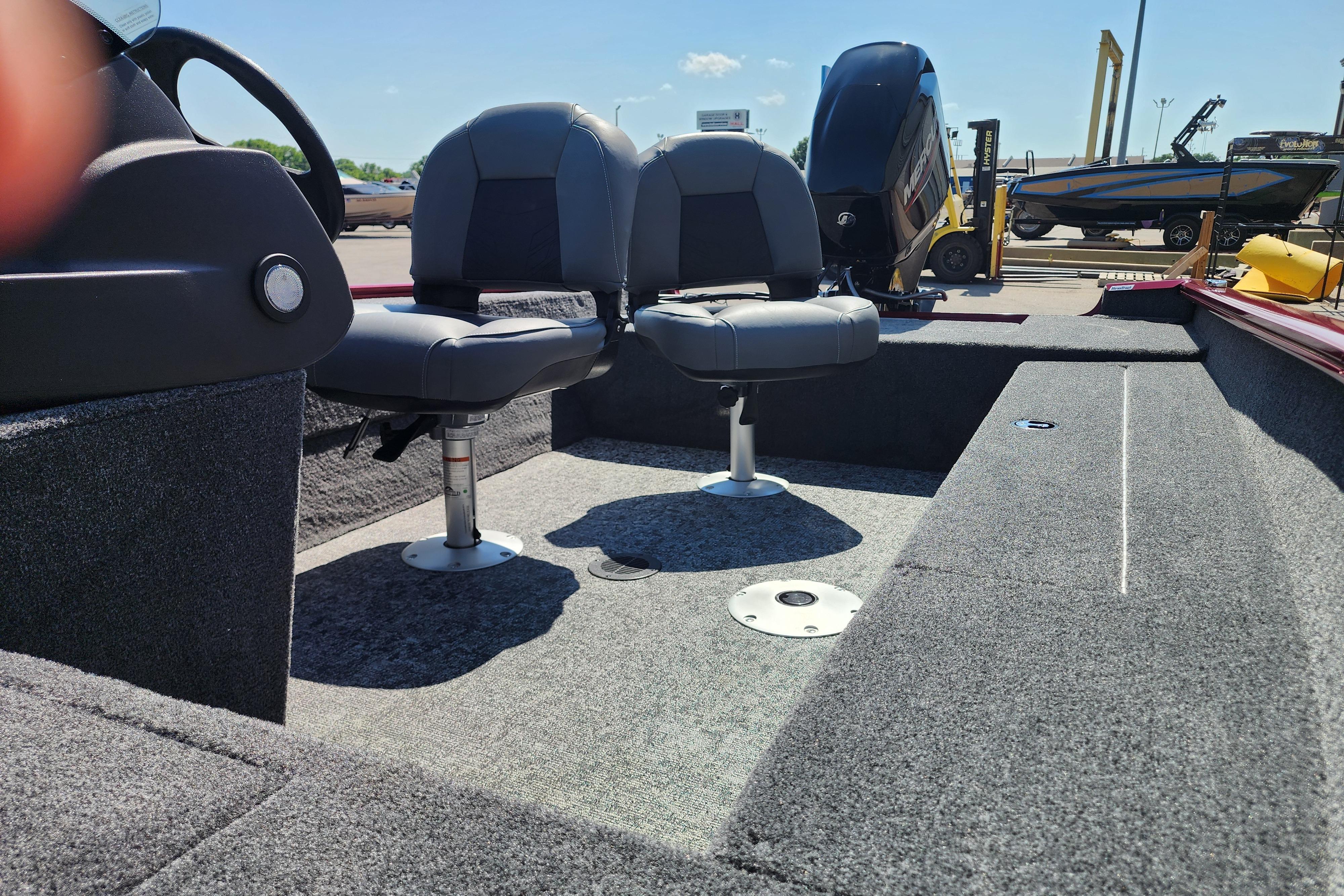 2026 Tracker Super Guide V-16 SC boat interior with two swivel seats and carpeted flooring.