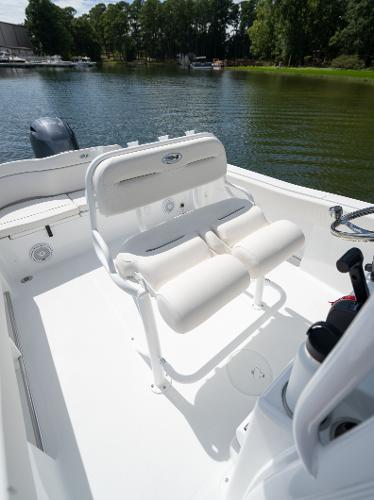 2024 Sea Hunt Ultra 234 boat interior with cushioned seating on a calm lake.