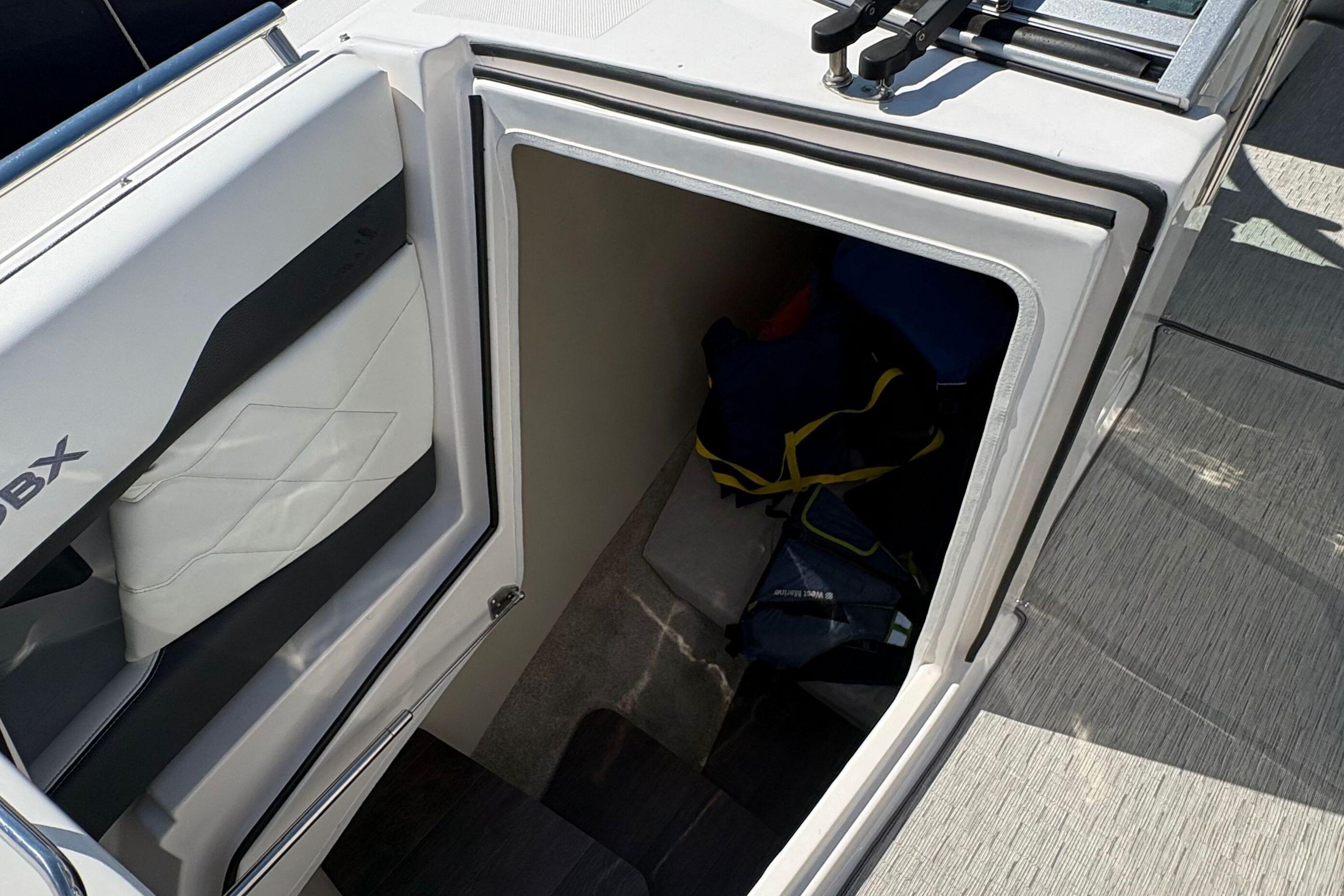 2020 Regal 33 OBX boat interior storage compartment with life jackets.