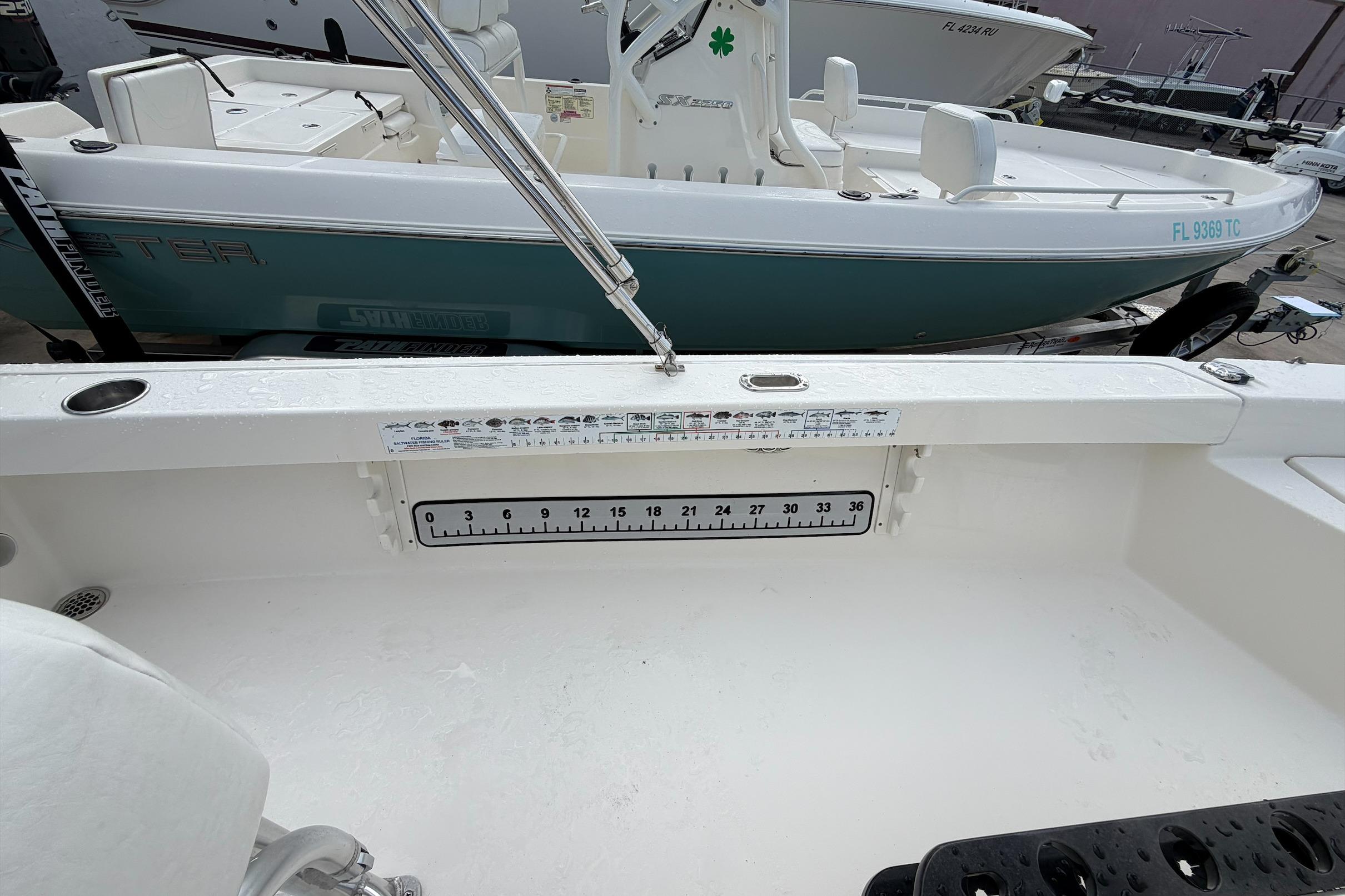 2017 Pathfinder 2200 TRS boat interior with measurement scale and fishing rod holders.