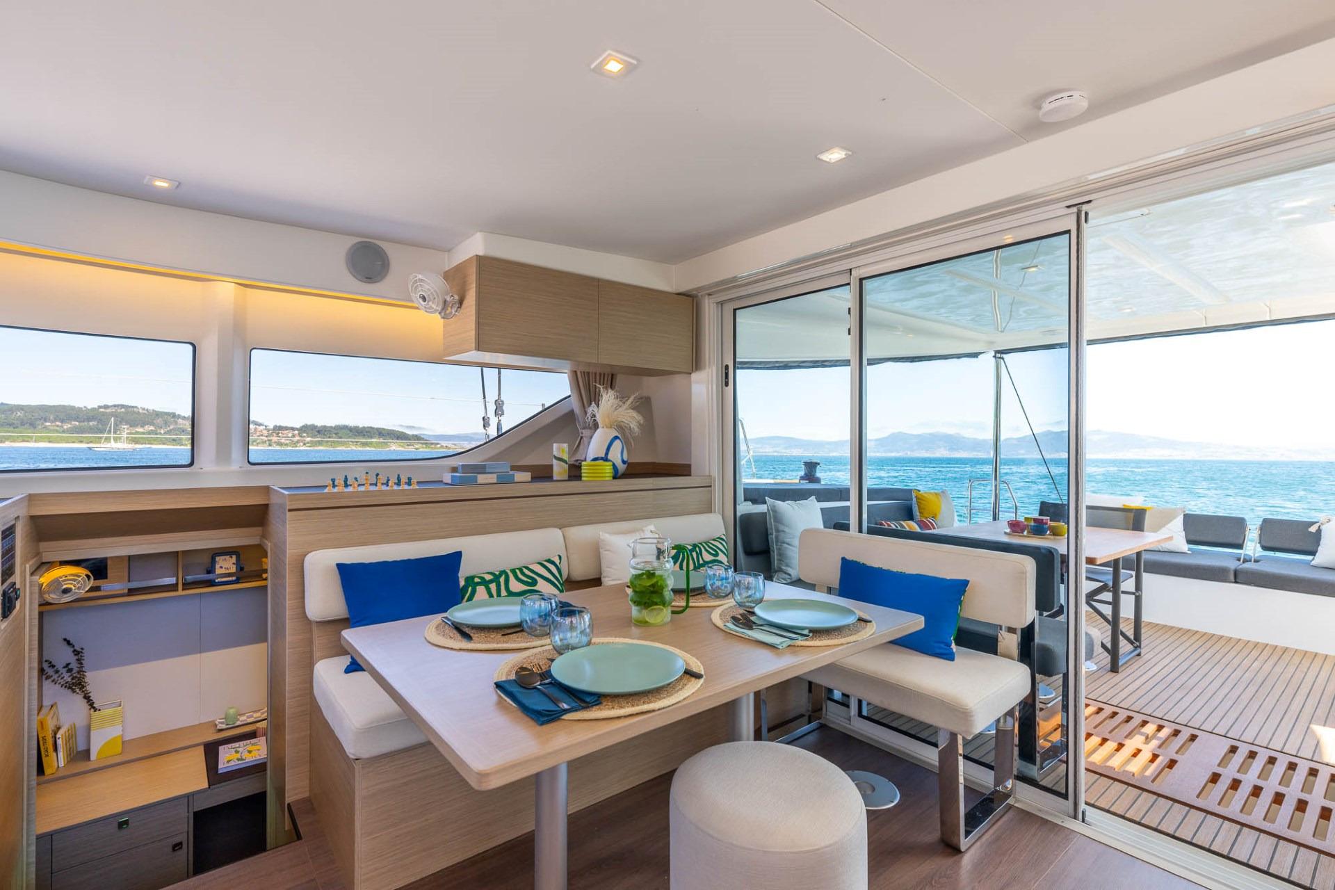 Manufacturer Provided Image: Luxurious interior of 2025 Lagoon 43 yacht with ocean view and elegant dining area.