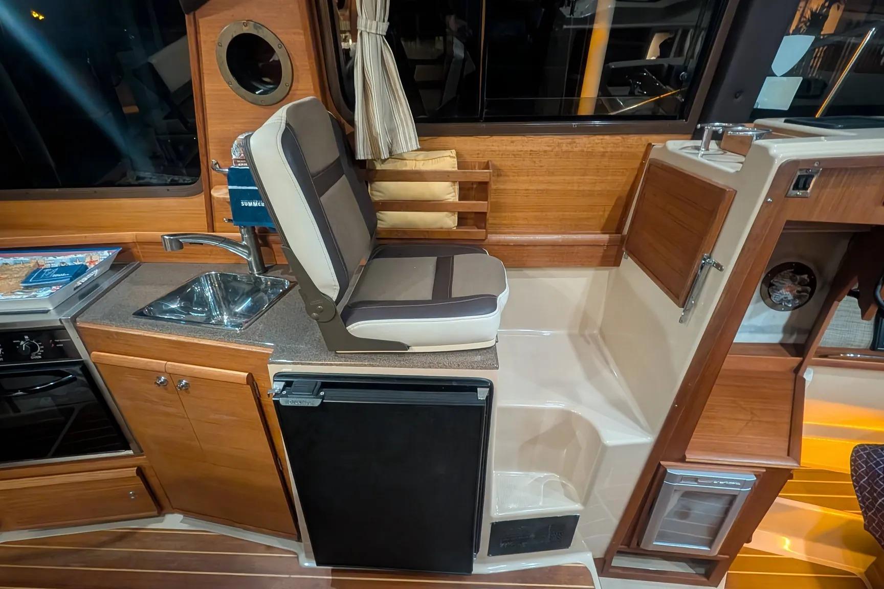 Interior of 2015 Ranger Tugs R-29 S with kitchenette and seating area.