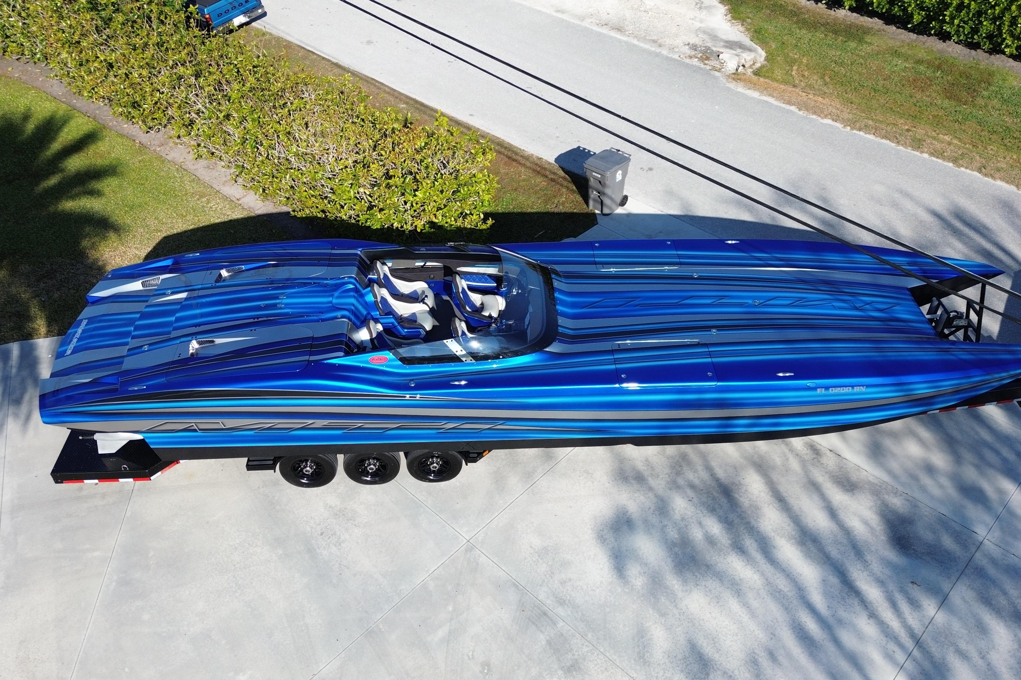 2016 MTI 44 RP speedboat with blue and black stripes on a trailer.