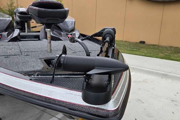 2025 Ranger Z518 boat with trolling motor on deck, parked outdoors.