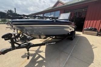 2026 Nitro ZV19 Sport Pro boat on trailer outside a red building.