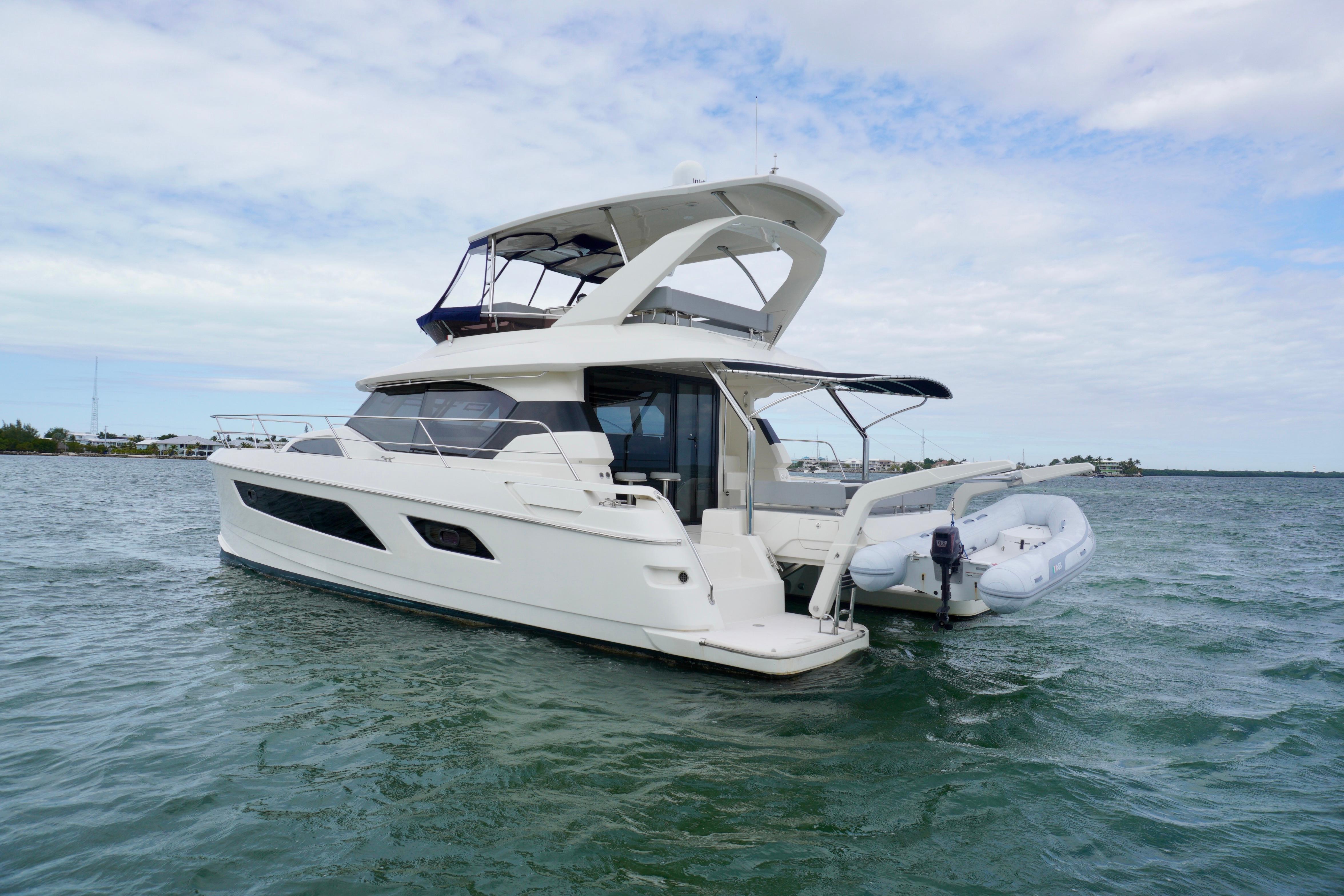 2017 Aquila 44 Yacht cruising on open water under a cloudy sky.