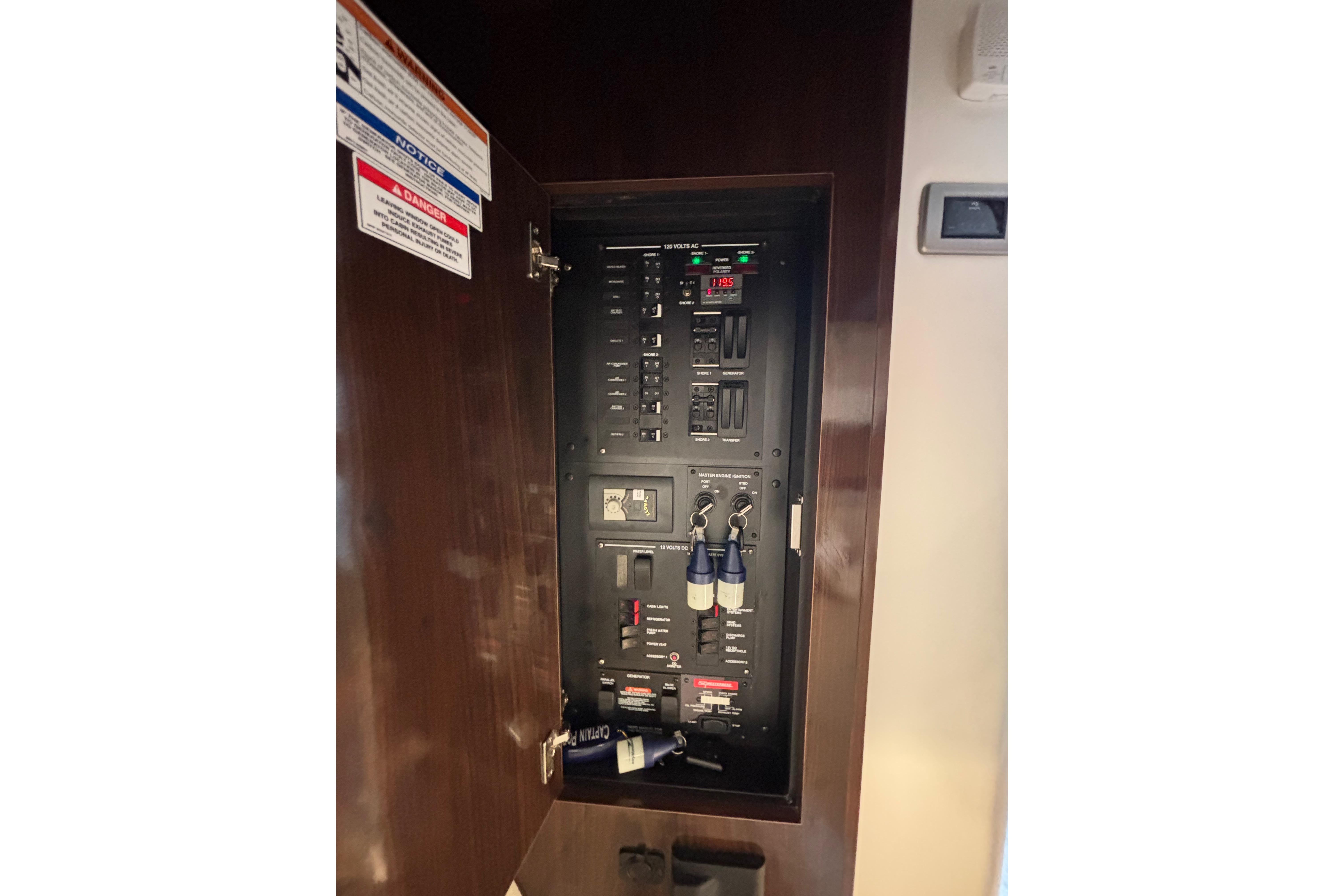 Electrical panel inside 2021 Sea Ray Sundancer 320 Outboard boat, featuring various switches and controls.