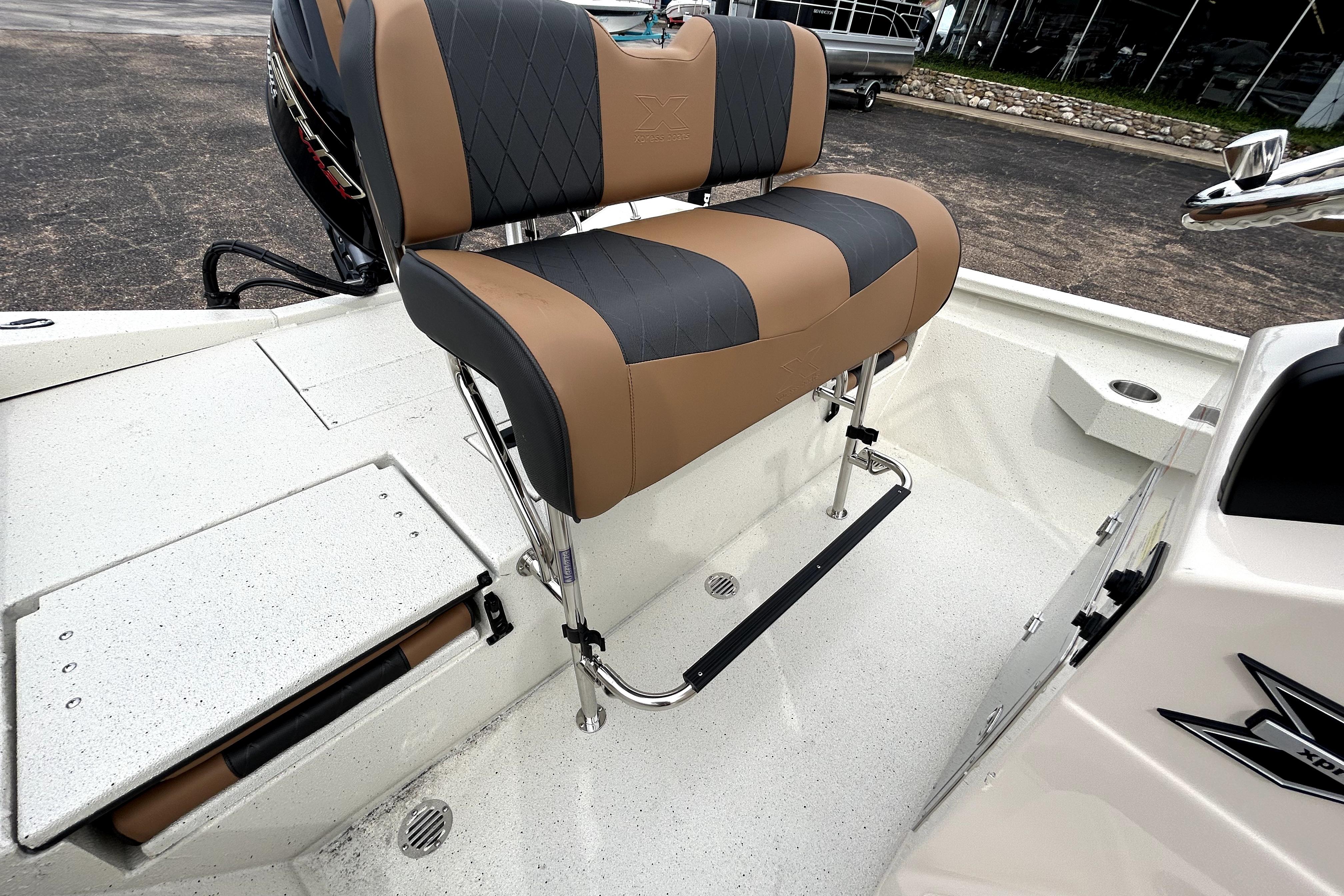 2026 Xpress H20B Bay boat interior with cushioned seating and storage compartment.
