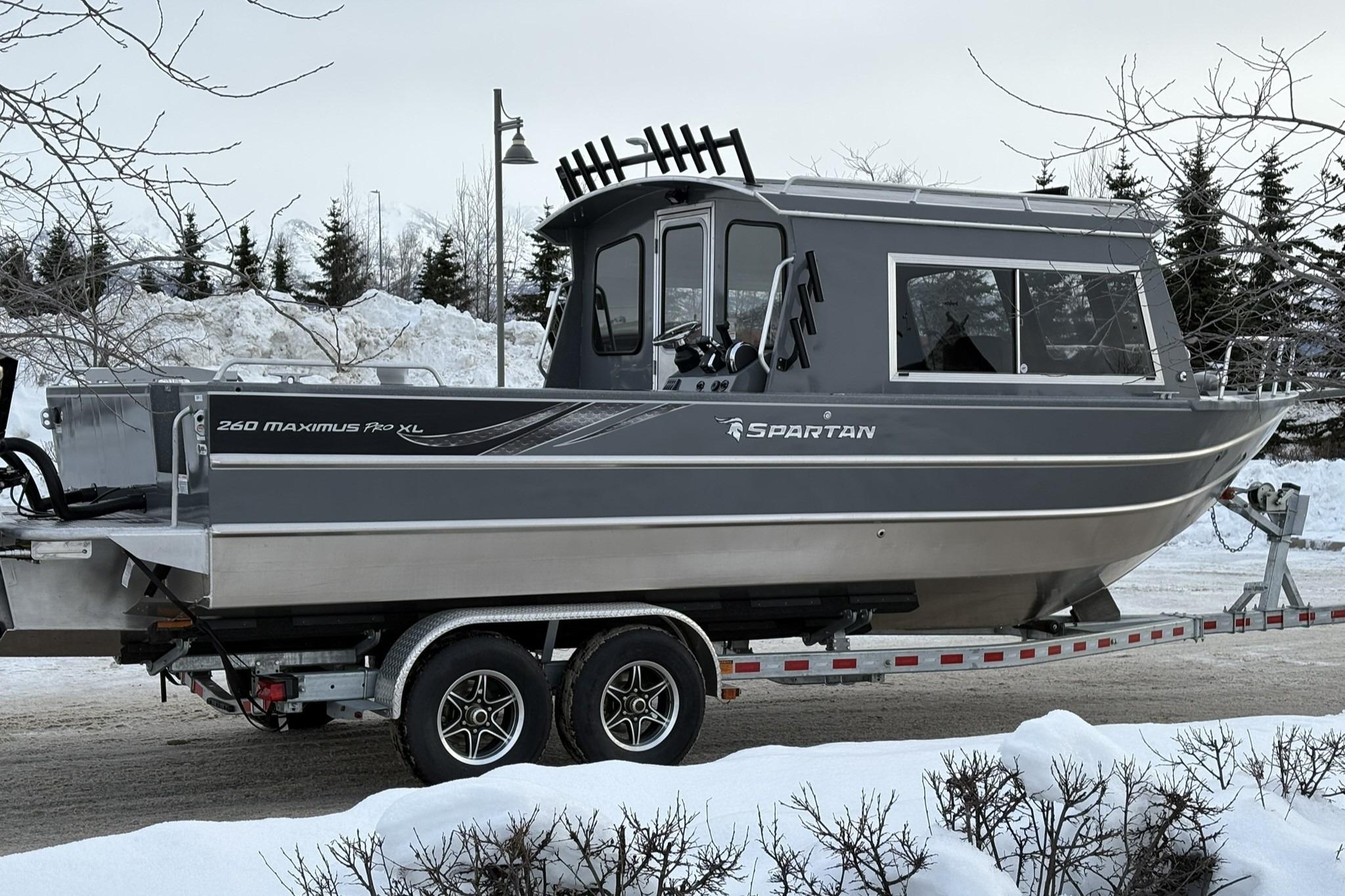 2024 Spartan 26 Maximus Pro XL boat on trailer in snowy landscape.