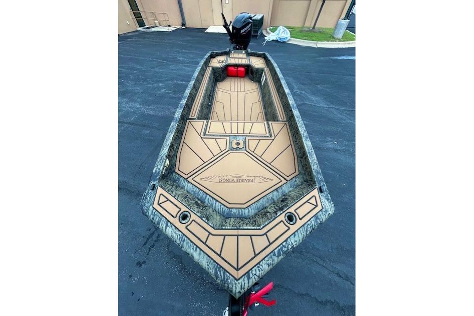 2026 Tracker Grizzly 1650 T Prairie Wings Edition boat with camo design and spacious deck.