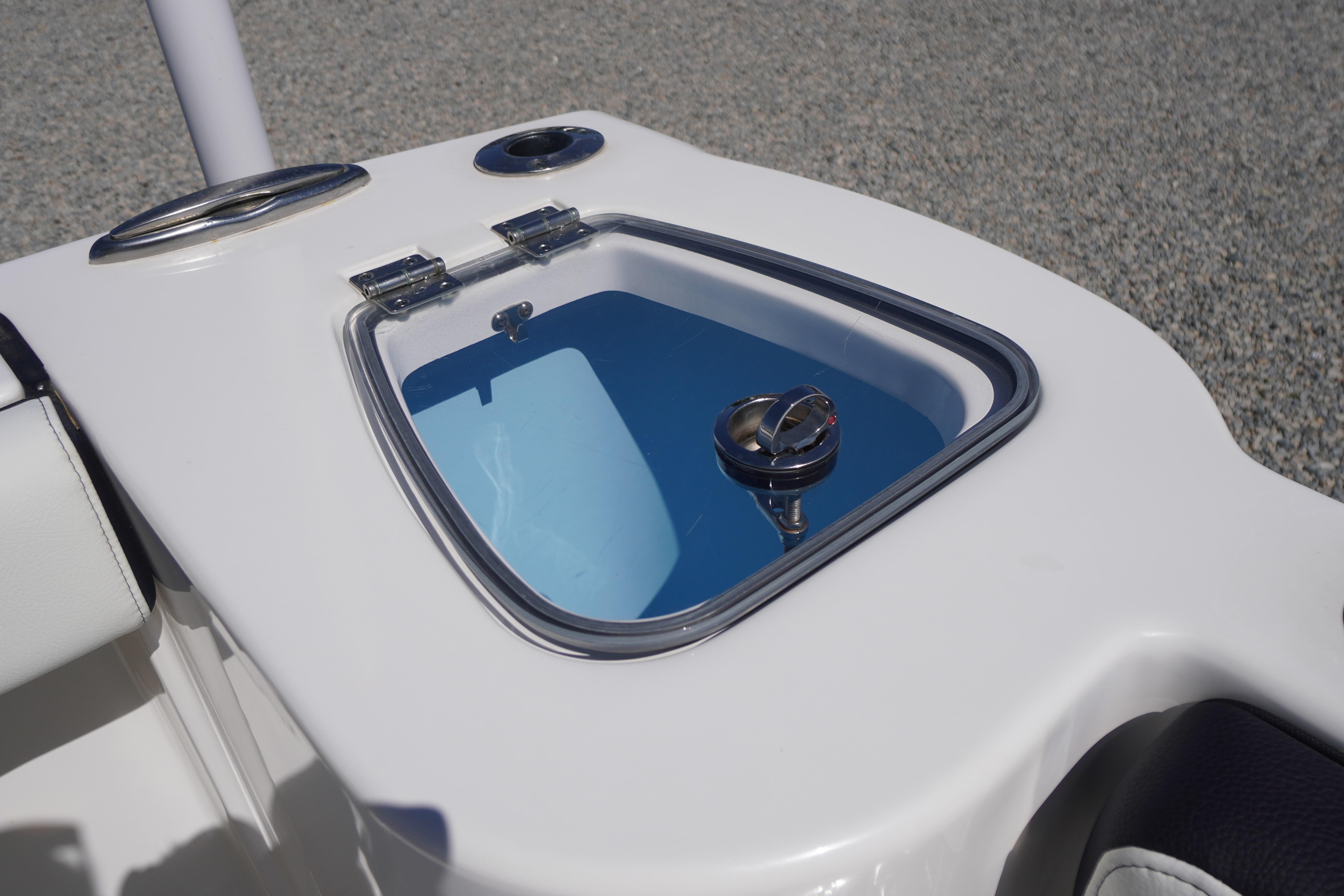 2024 Tidewater 232 CC Adventure boat livewell with open lid, showcasing interior details.