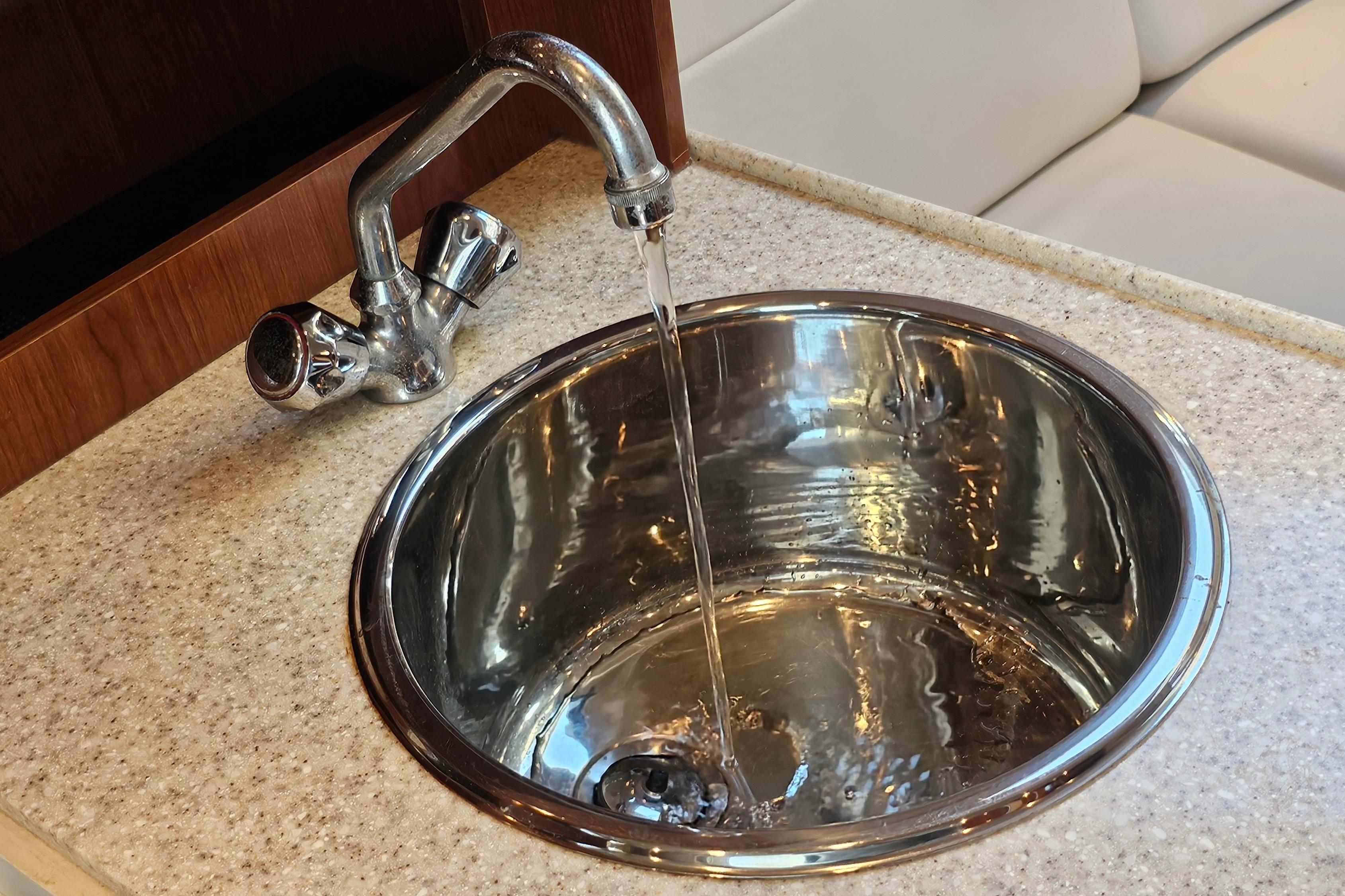 Stainless steel sink with running water in 2005 Regal 3060 Window Express boat.