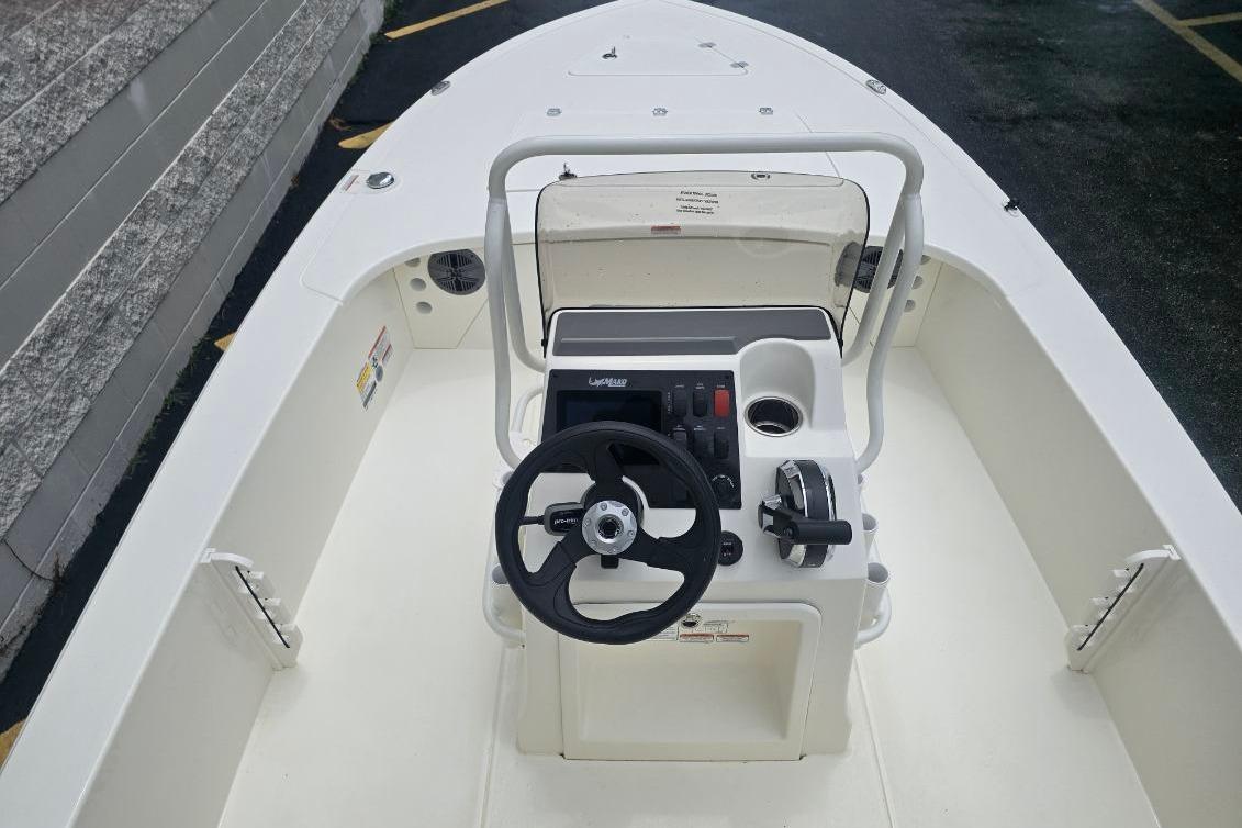 2026 Mako 18 Pro Skiff boat interior with steering wheel and control panel.
