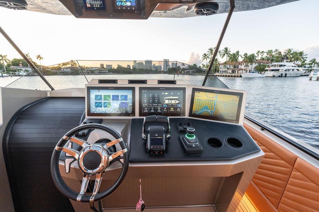 Helm of 2023 DeKoning 43 yacht with advanced navigation displays and luxurious interior.