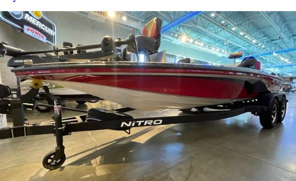 2025 Nitro Z19 boat on display in a showroom, featuring a sleek red design.