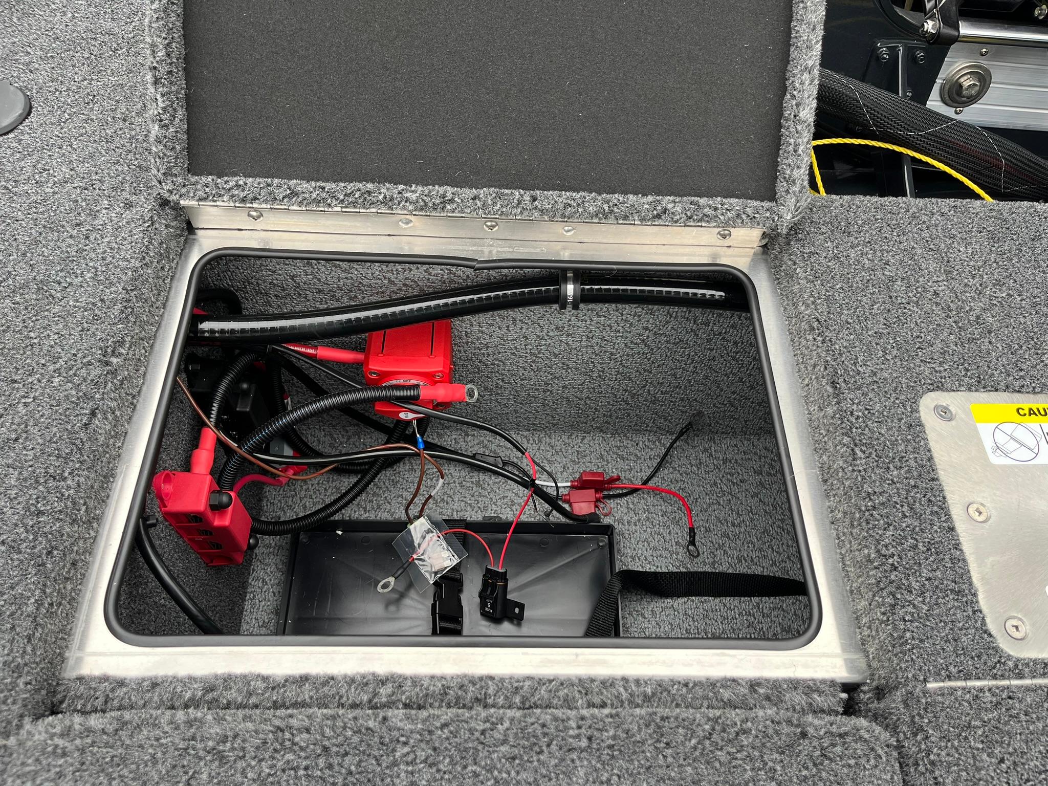 Open battery compartment of 2026 Lund 1875 Pro-V Bass XS boat.