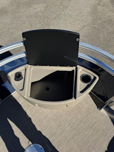Sun Tracker Fishin' Barge 22 DLX 2025 with storage and cup holders.