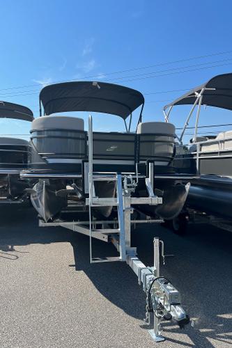 2024 Starcraft SLS 3 Q DH pontoon boat on a trailer under a clear blue sky.