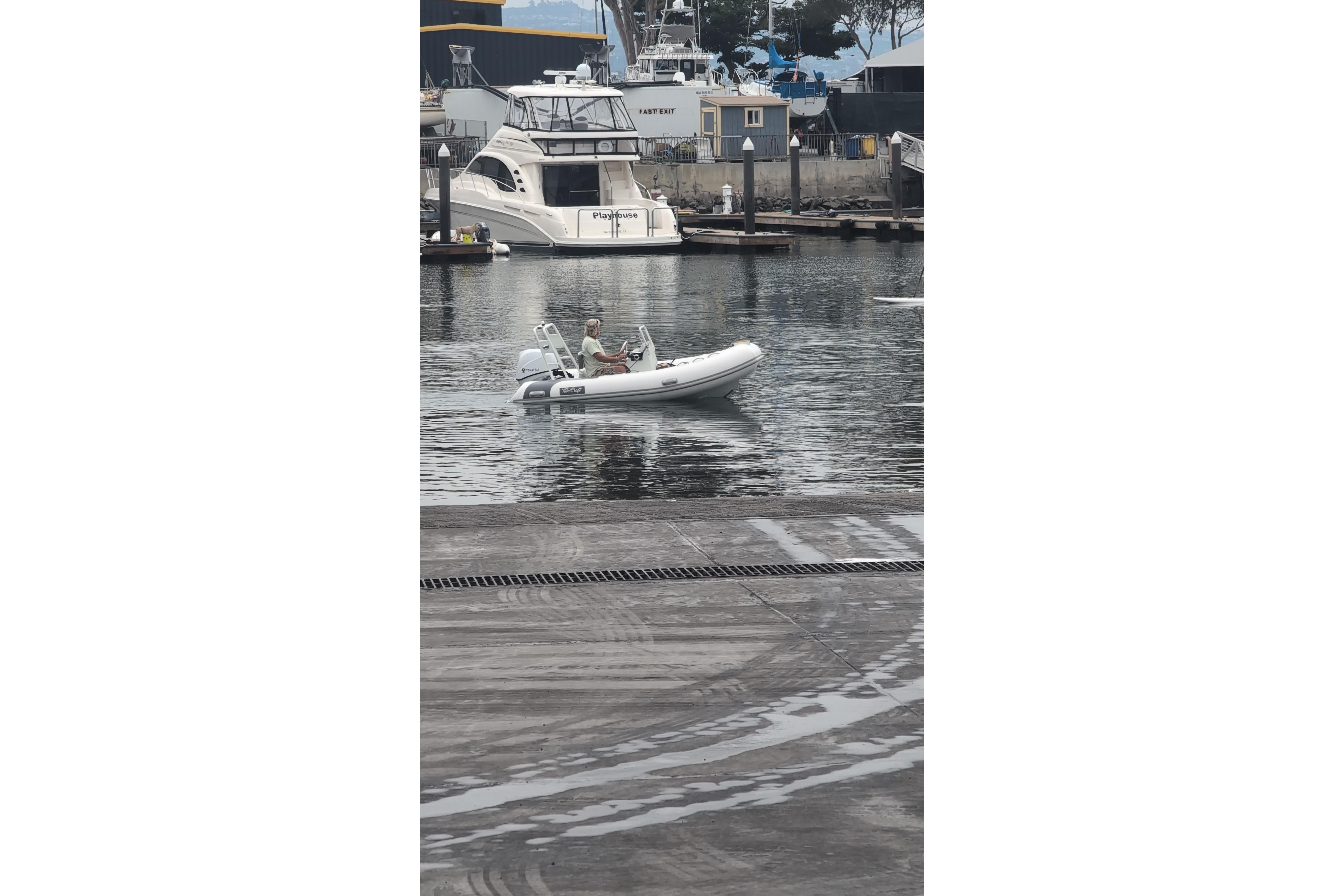 Small boat navigating marina, featuring 2027 Tide Craft San Juan 11 model.