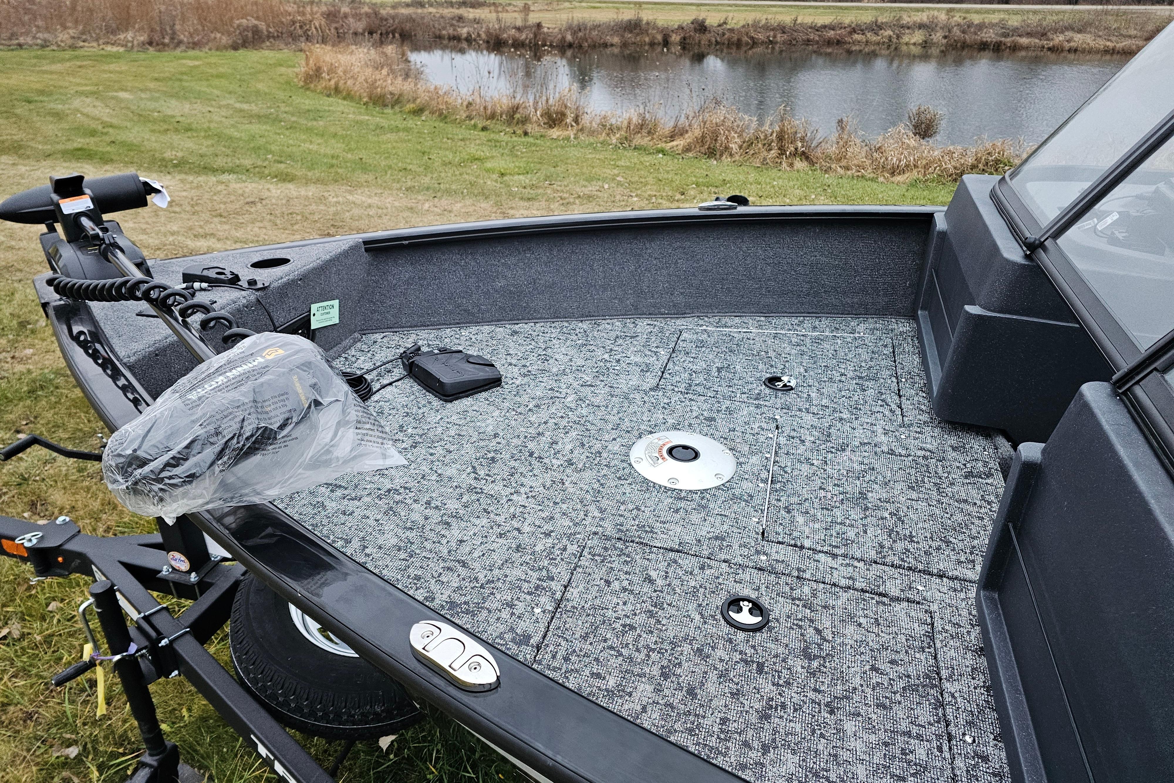 2026 Tracker Pro Guide V-175 WT boat with spacious deck near a serene pond.