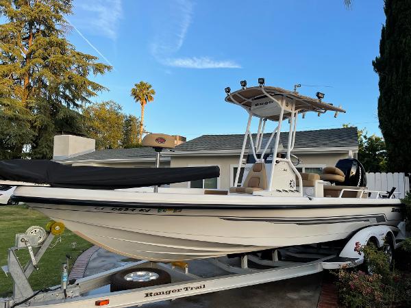 2006 Ranger 2400 Bay Ranger boat on trailer in residential yard.