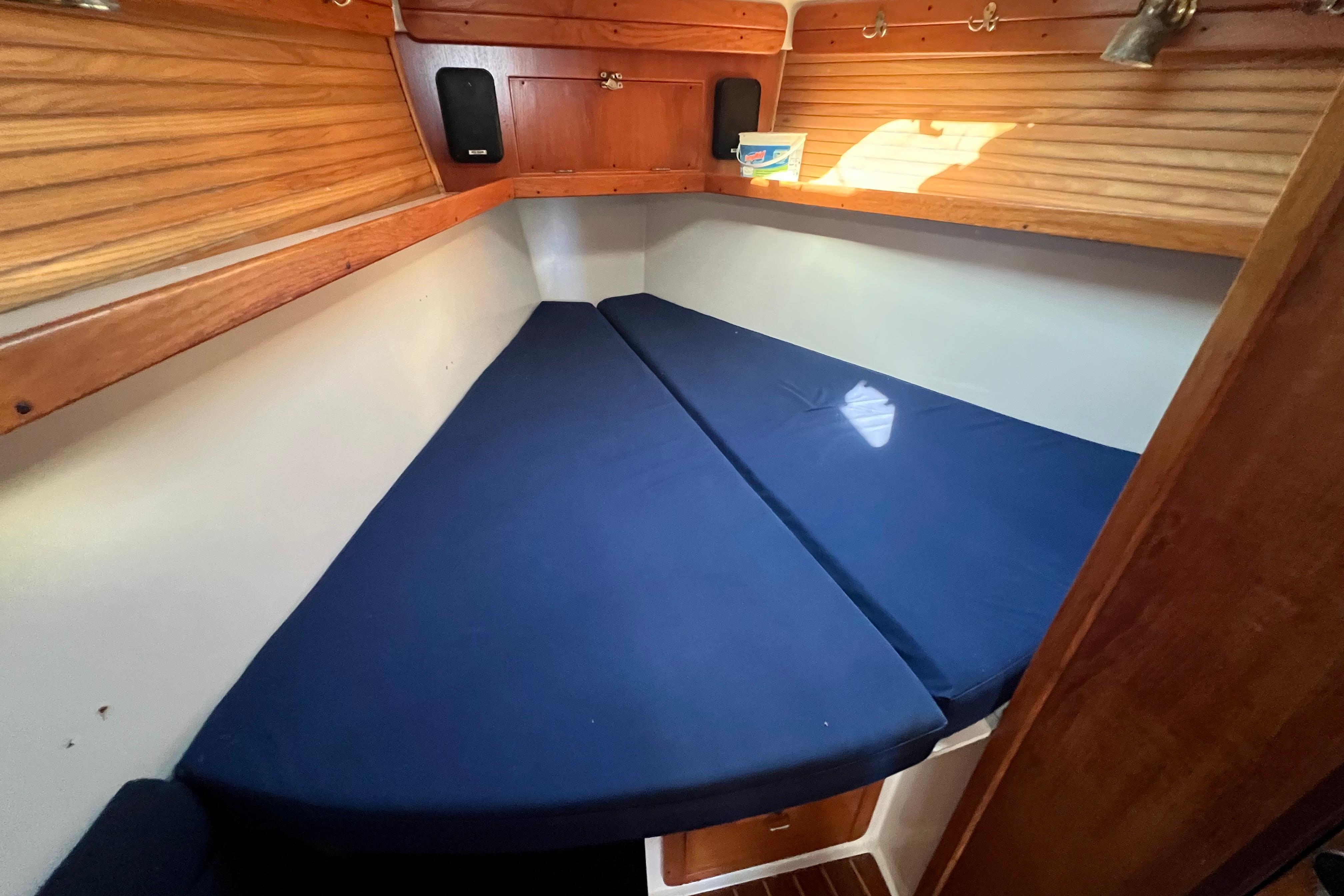 1996 Catalina 400 sailboat cabin with blue cushions and wooden interior.
