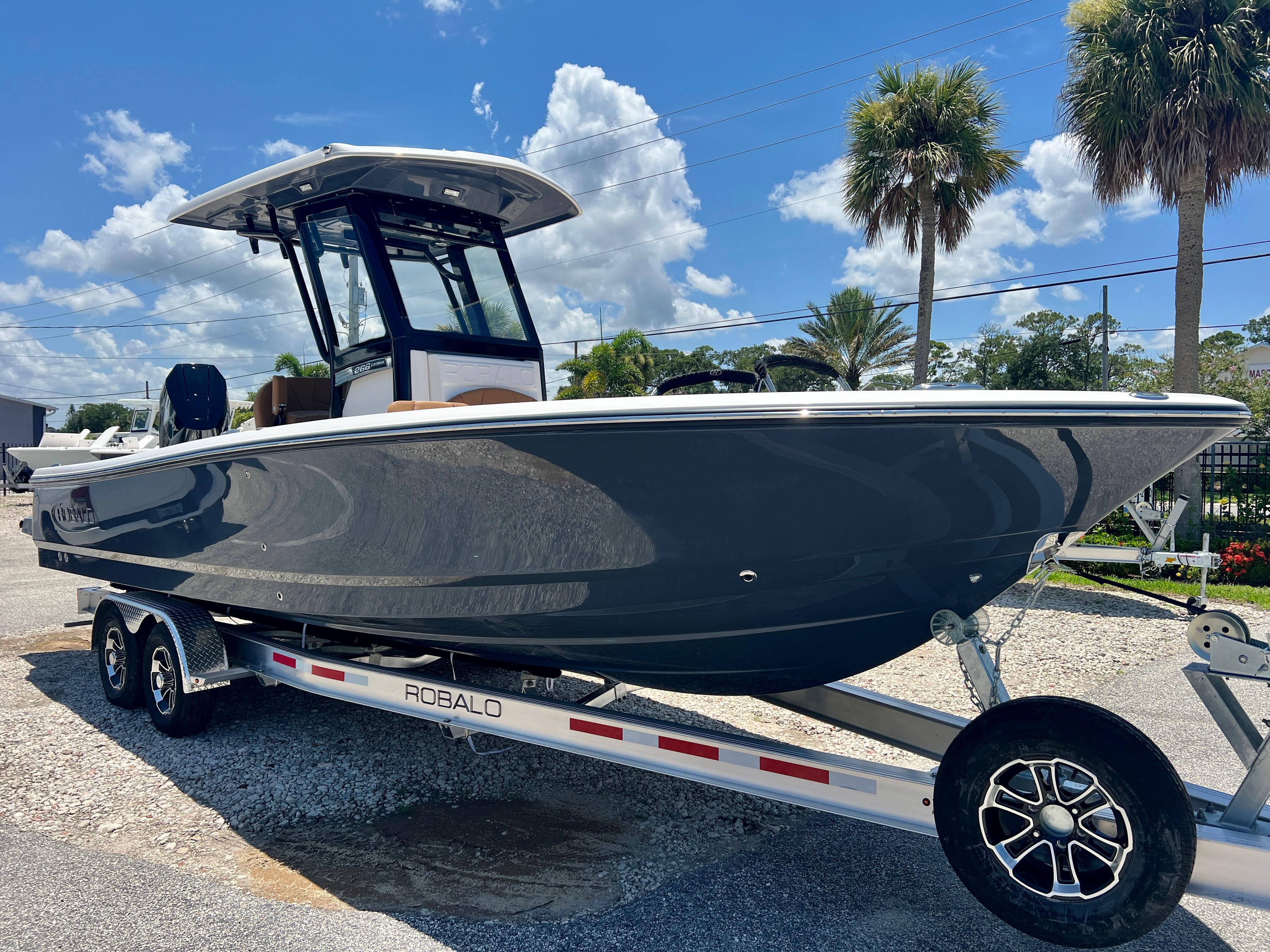 2025 Robalo 266 Cayman boat on trailer, sunny day.