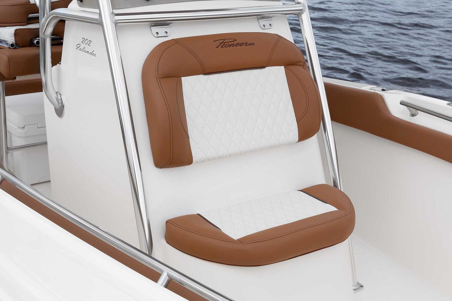 Manufacturer Provided Image: 2025 Pioneer 202 Islander boat seat with brown and white upholstery, on calm water.