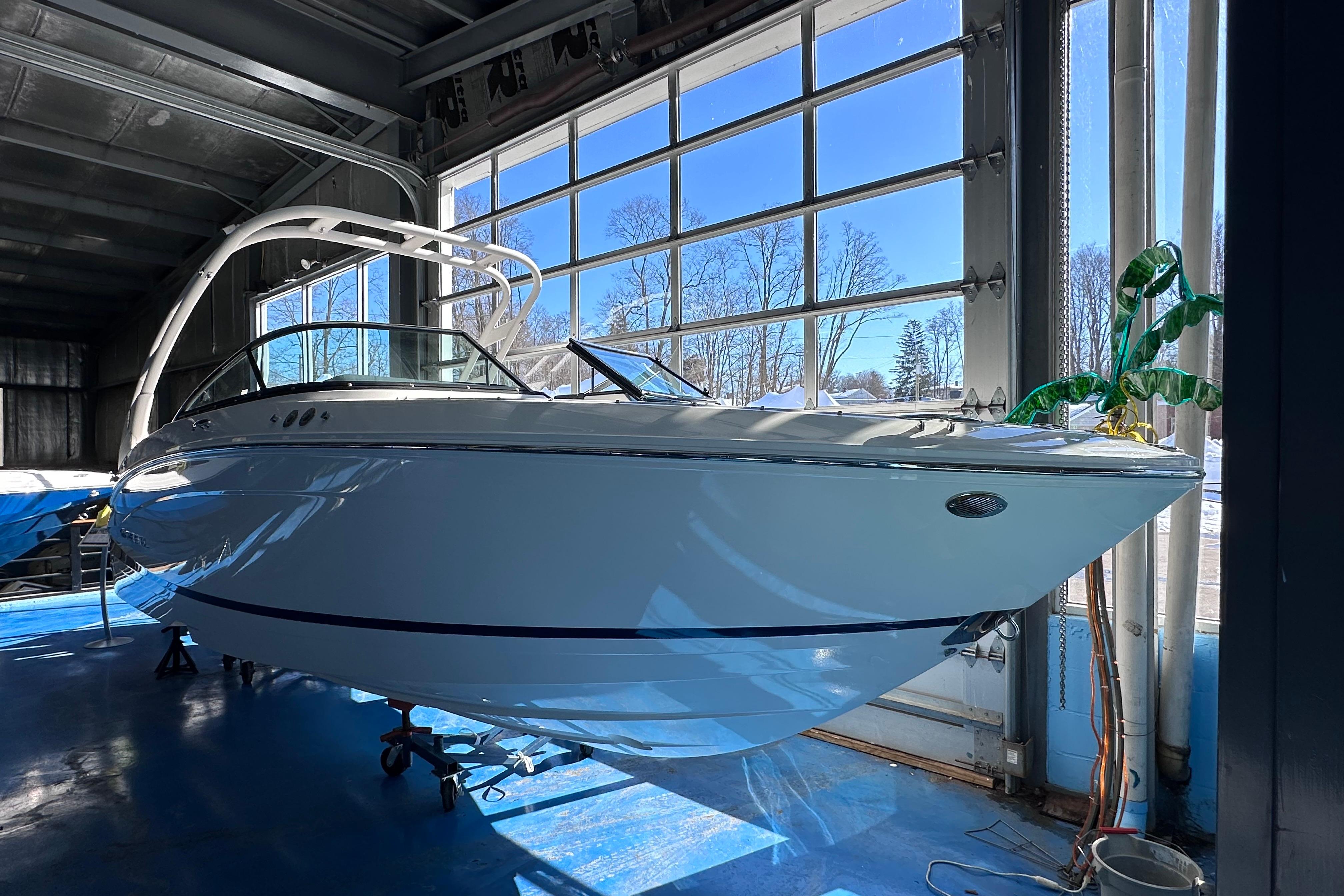 2026 Regal LX4 boat in a sunlit garage, showcasing sleek design and modern features.