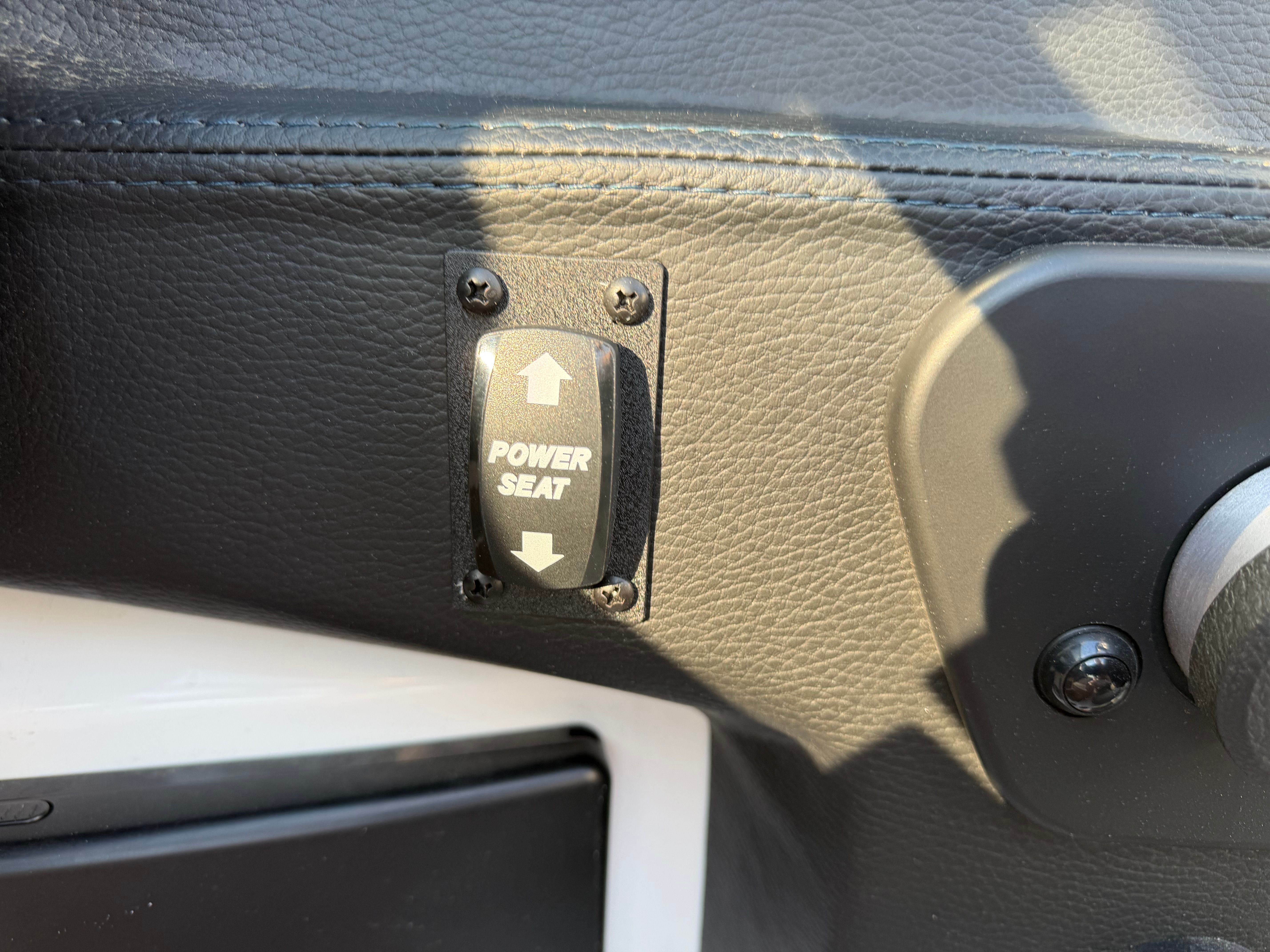 Close-up of a switch labeled "Power Seat" in a 2021 Malibu Wakesetter 23 LSV.