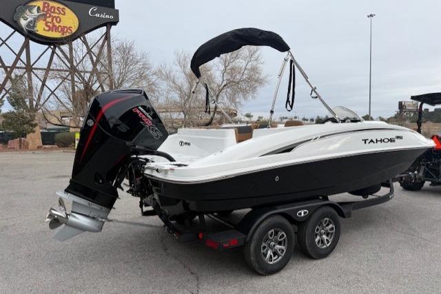 2026 Tahoe 1950 boat on trailer near Bass Pro Shops, featuring sleek design and powerful engine.