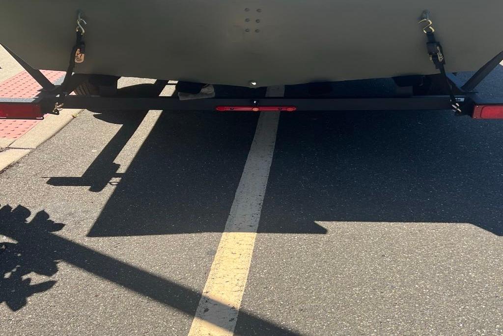 Rear view of 2026 Tracker GRIZZLY 2072 Utility trailer on a road.