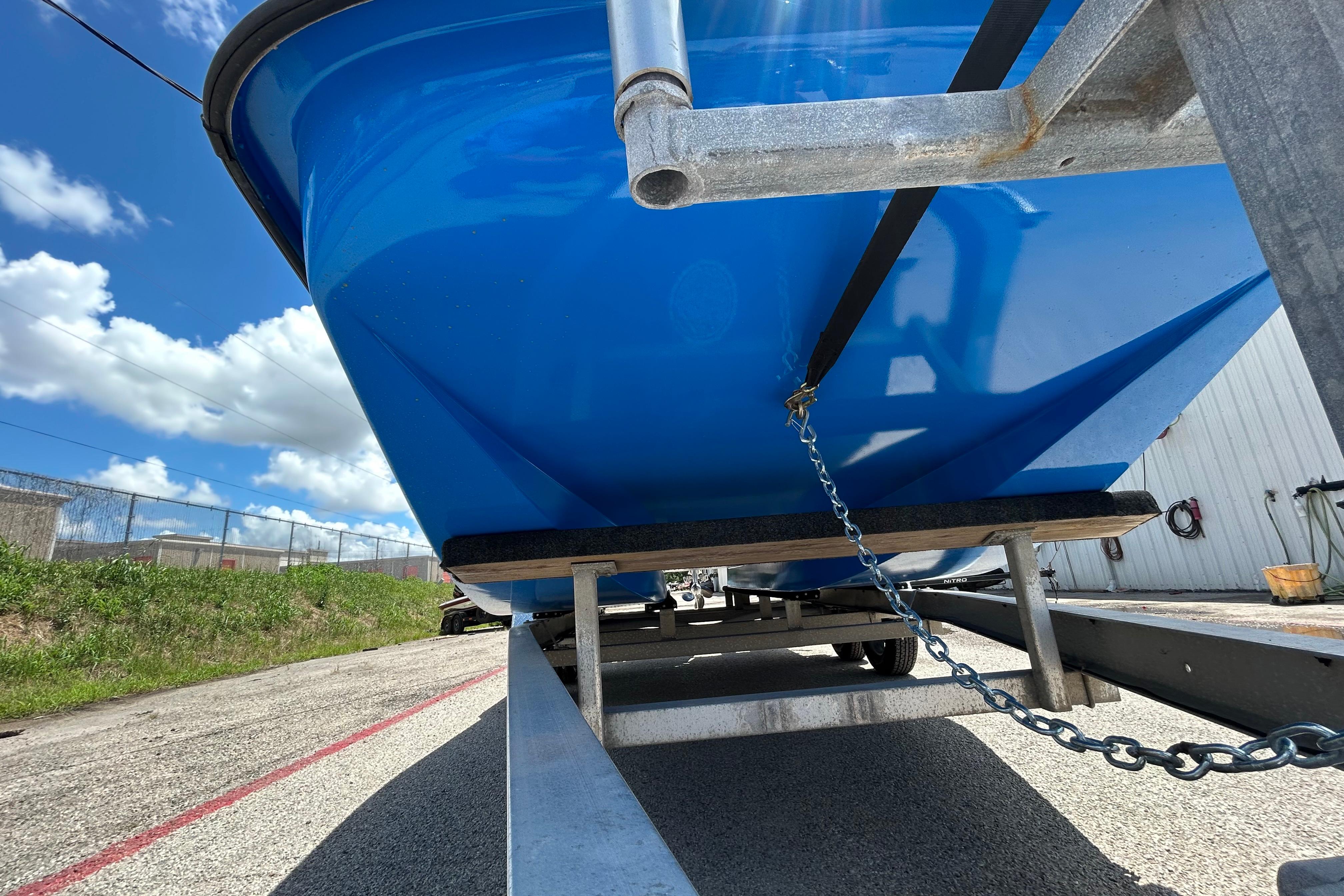 Blue 2007 Flats Cat 19 boat on trailer under sunny sky.