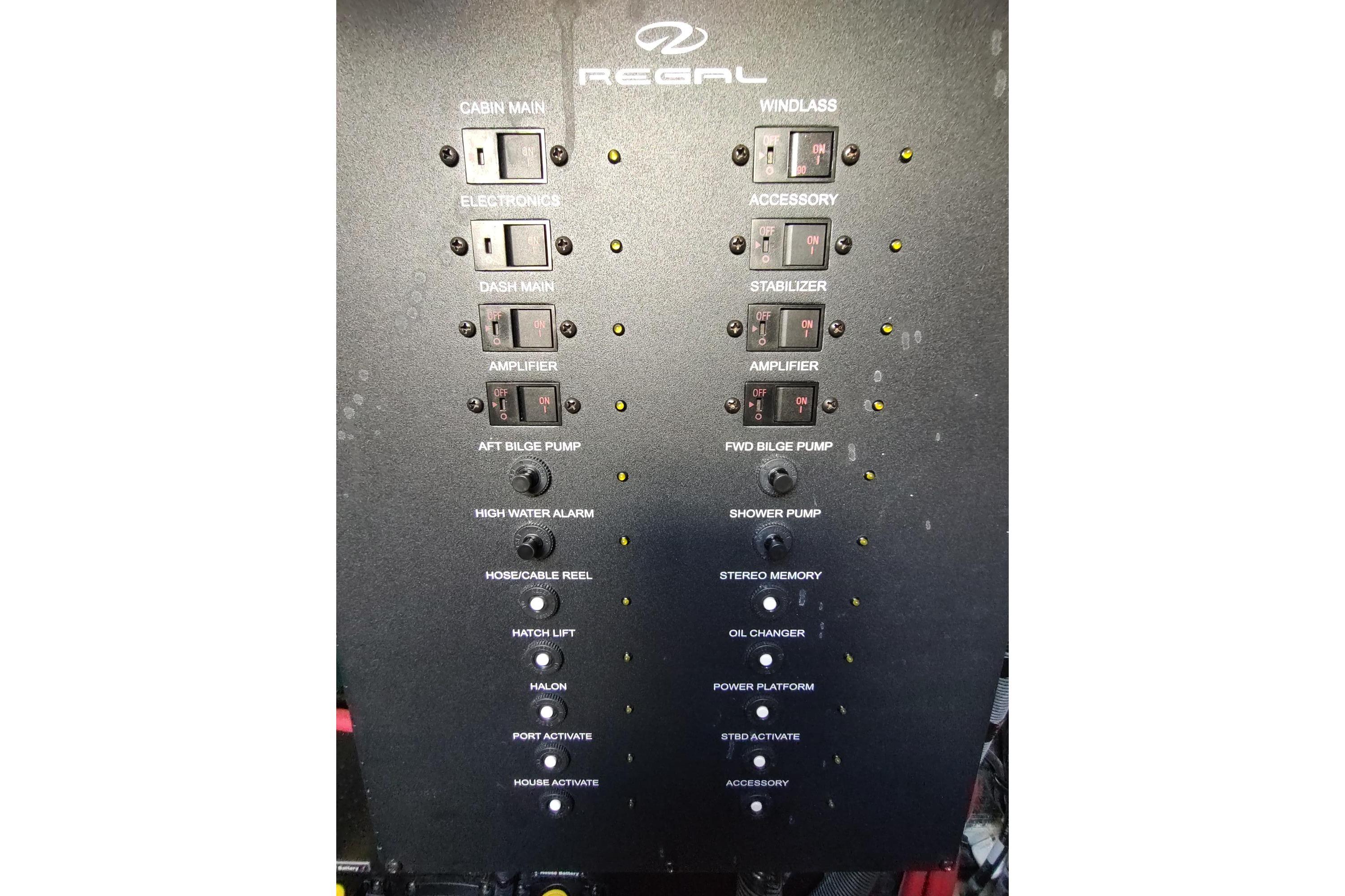 Control panel of a 2021 Regal 42 Fly yacht with various switches and indicators.