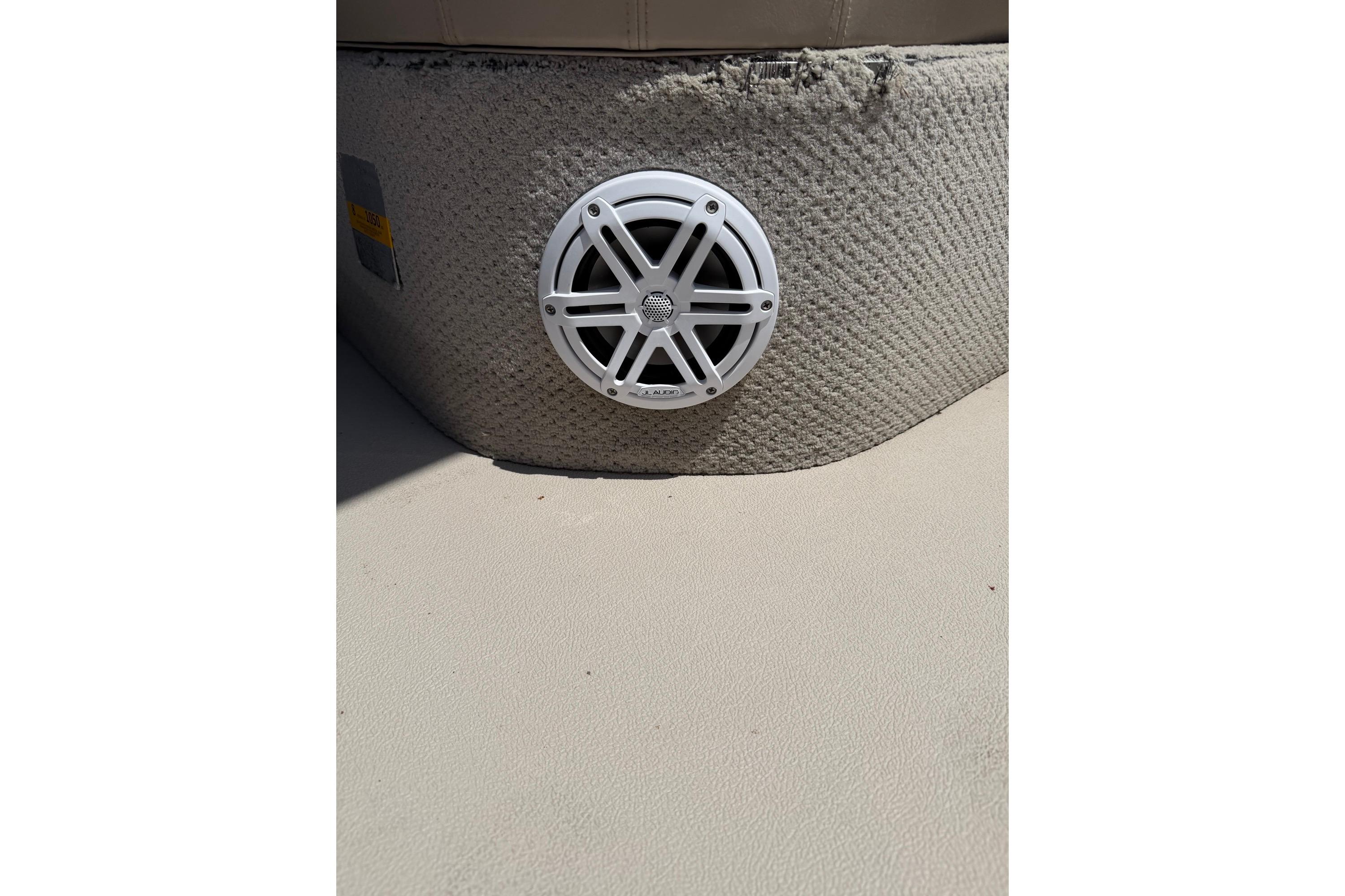 White speaker on textured surface of 2014 Avalon 1900 boat interior.