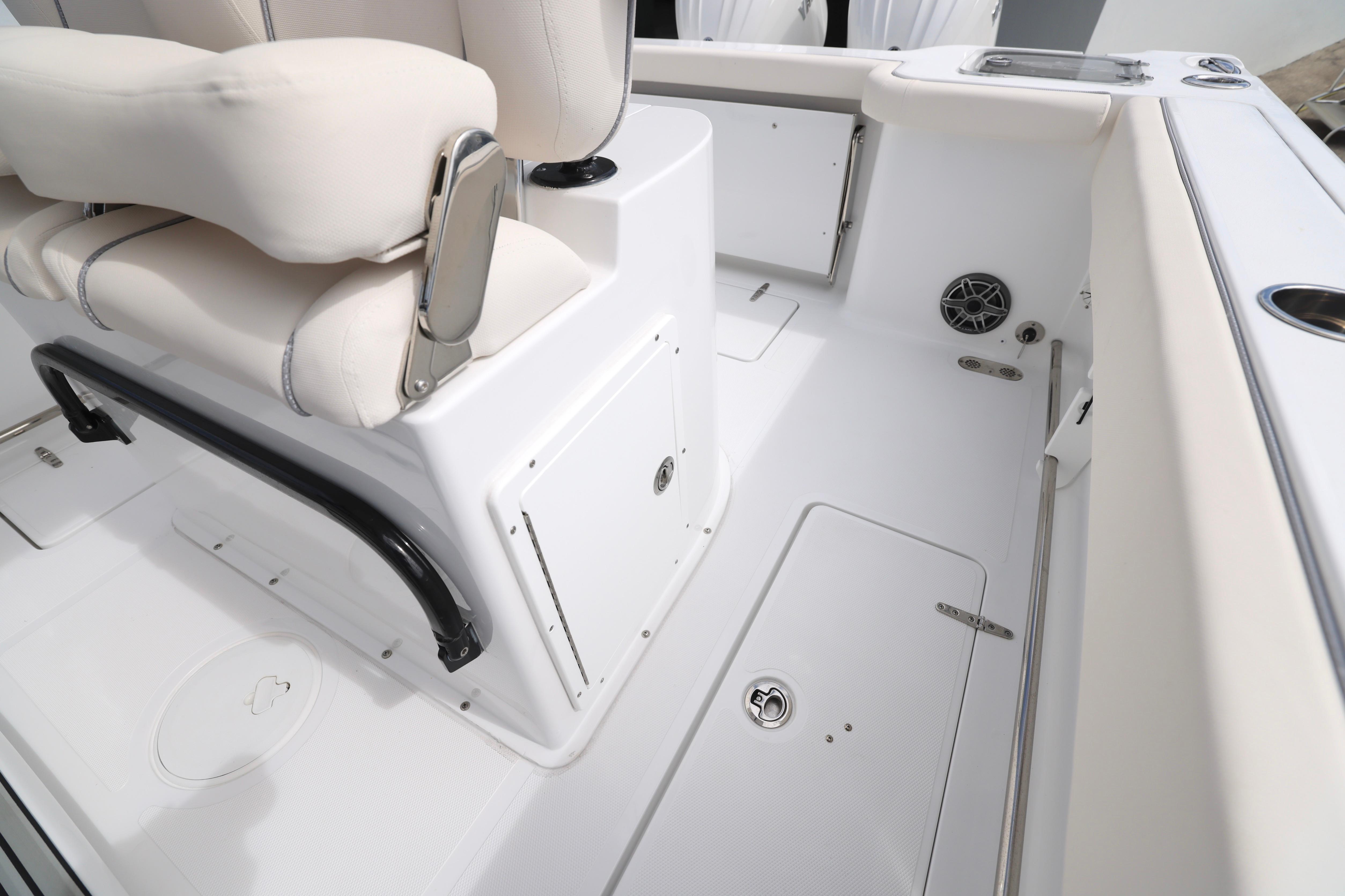 2026 Sea Hunt Gamefish 25 interior, featuring white seating and storage compartments.