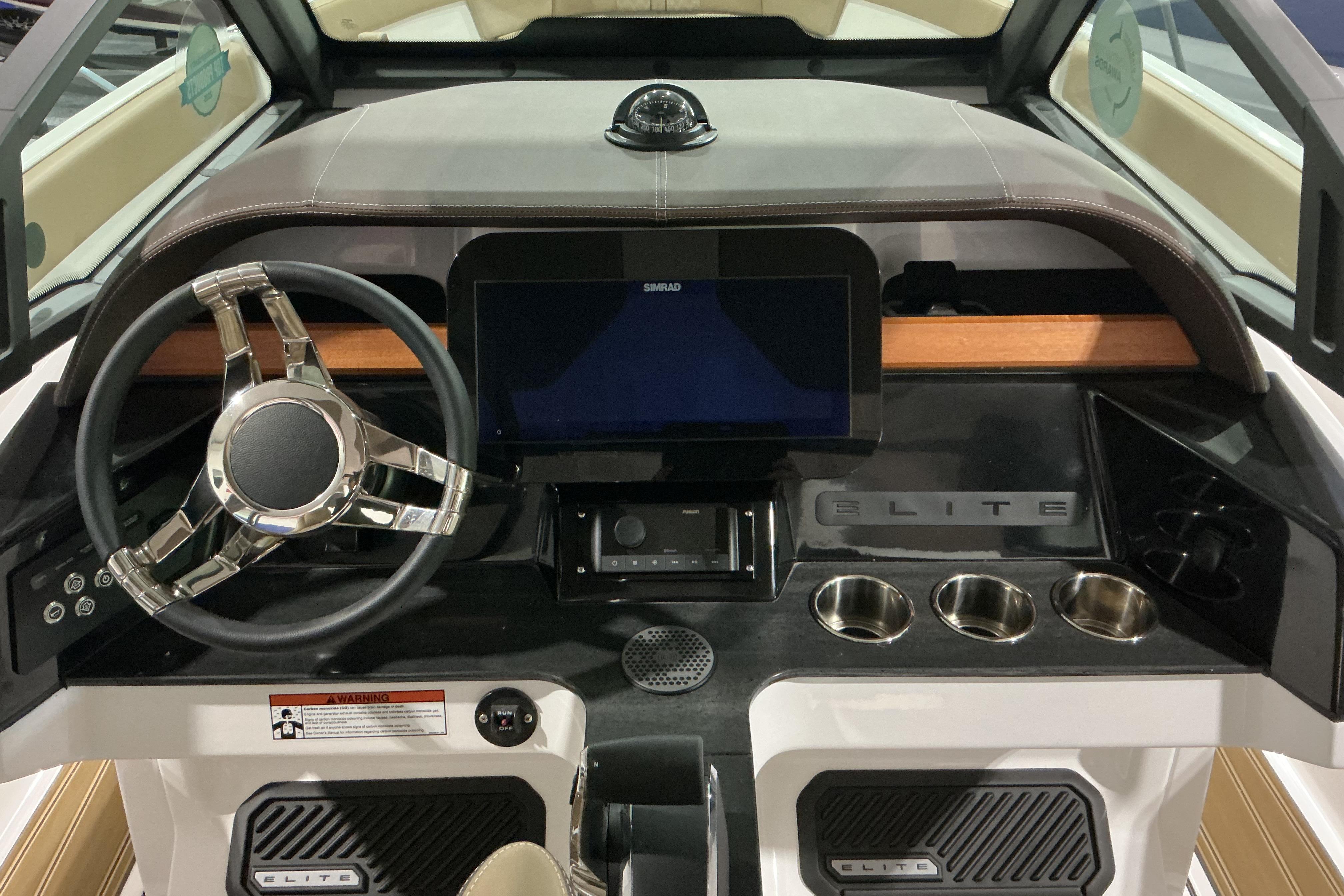 Dashboard of 2026 Monterey Elite 25 OB boat with modern steering and controls.