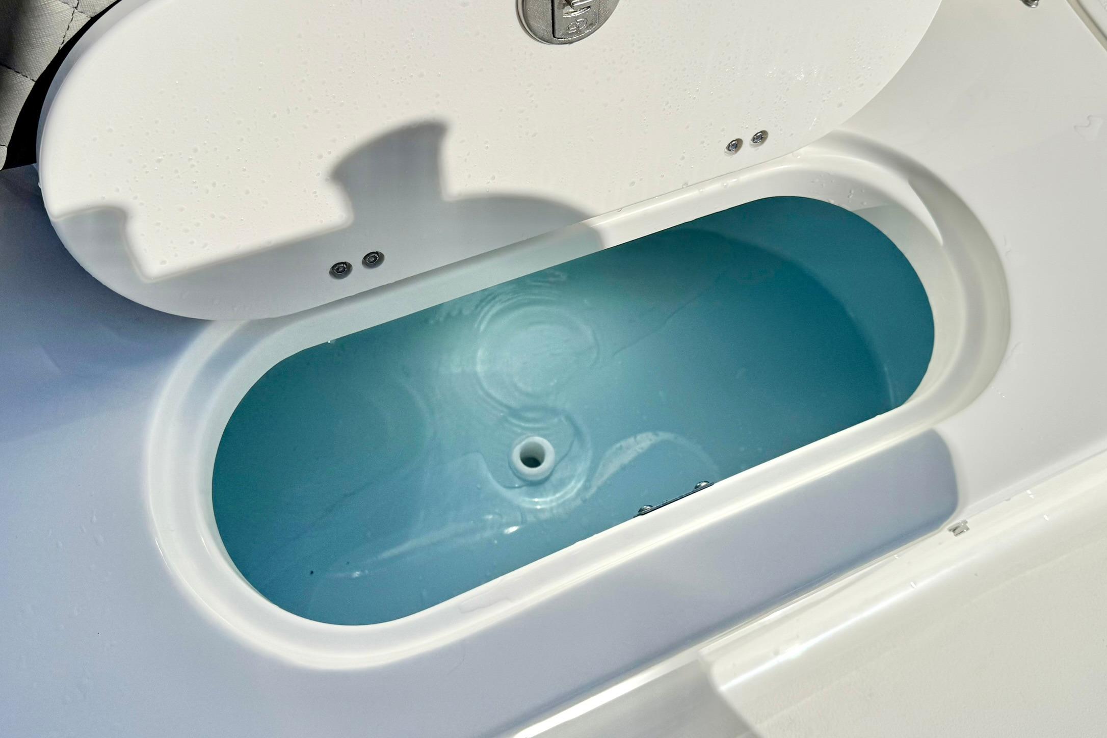 Livewell compartment on a 2026 Key West 189 FS boat, filled with water.